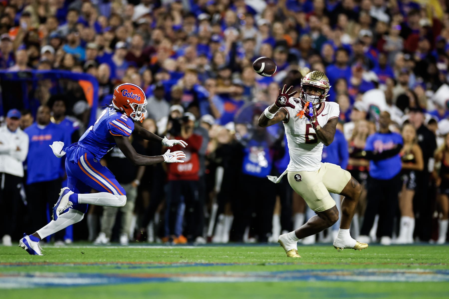 GAINESVILLE, FLORIDA - NOVEMBER 25: Jaheim Bell #6 of the Florida State Seminoles catches a pass against Ja'Keem Jackson #2 of the Florida Gators during the second half of a game at Ben Hill Griffin Stadium on November 25, 2023 in Gainesville, Florida. (Photo by James Gilbert/Getty Images)