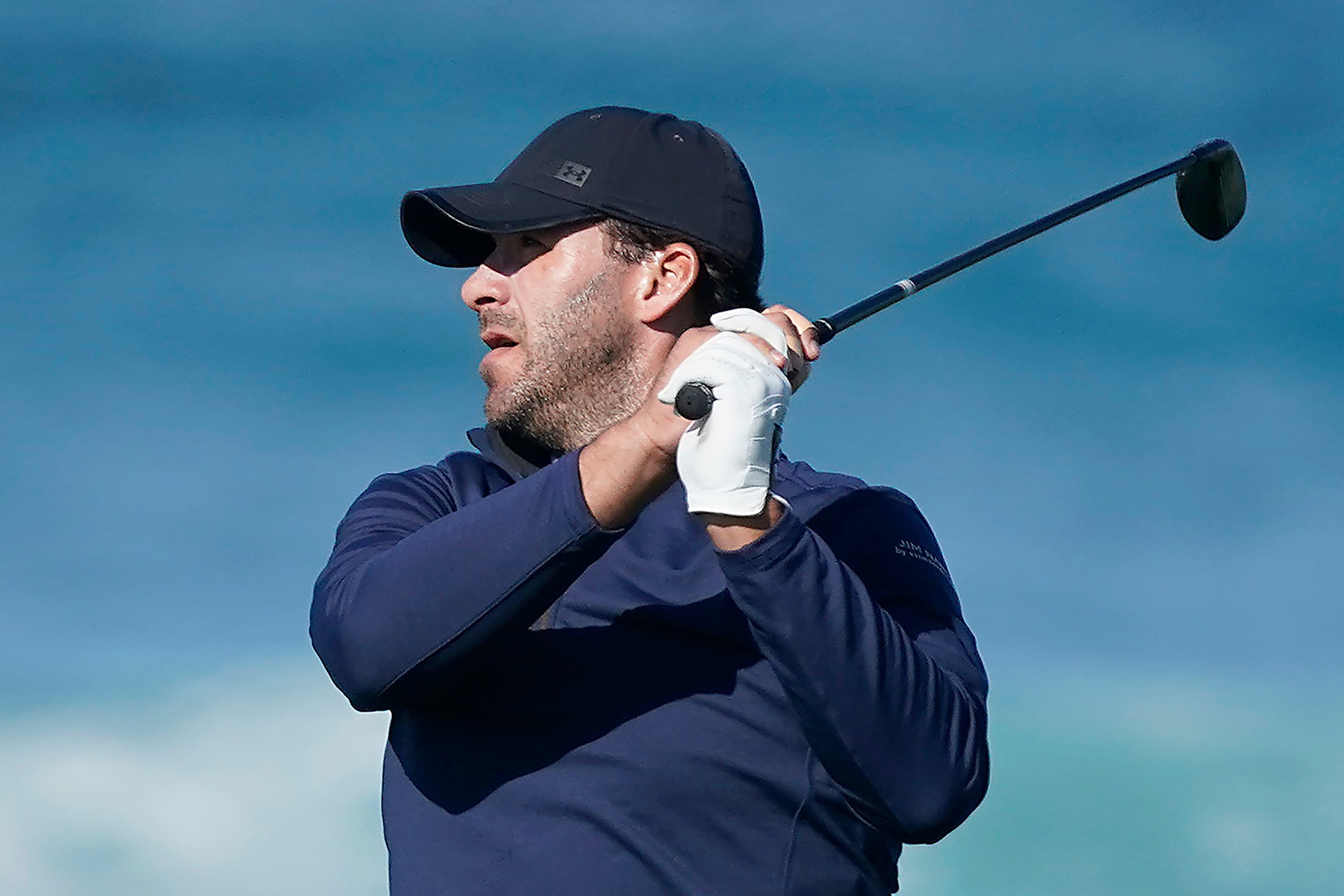 Tony Romo follows his shot from the 13th tee of the Monterey Peninsula County Club Shore Course during the second round of the AT&T Pebble Beach National Pro-Am golf tournament Friday, Feb. 7, 2020, in Pebble Beach, Calif. (AP Photo/Tony Avelar)
