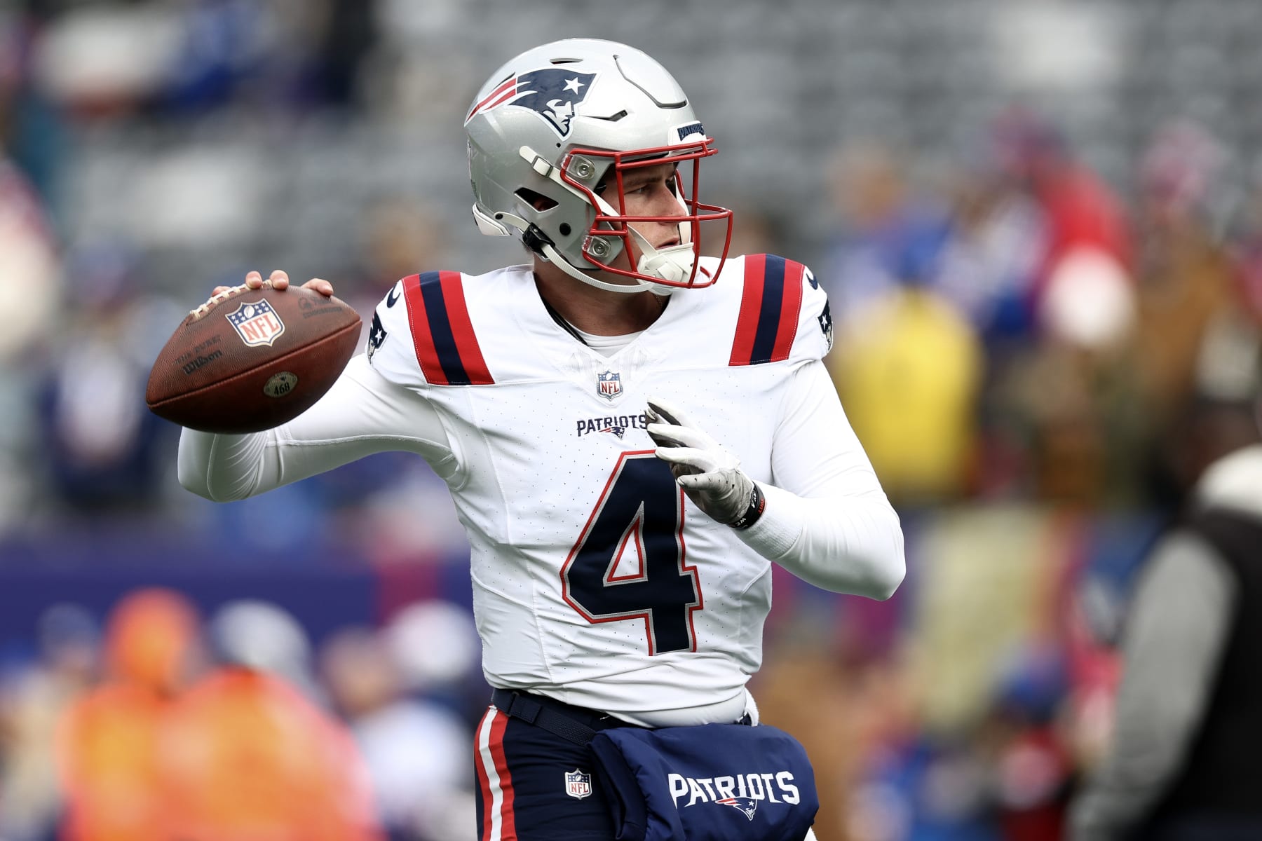 EAST RUTHERFORD, NEW JERSEY - NOVEMBER 26: Bailey Zappe #4 of the New England Patriots warms up prior to a game against the New York Giants at MetLife Stadium on November 26, 2023 in East Rutherford, New Jersey. (Photo by Elsa/Getty Images)