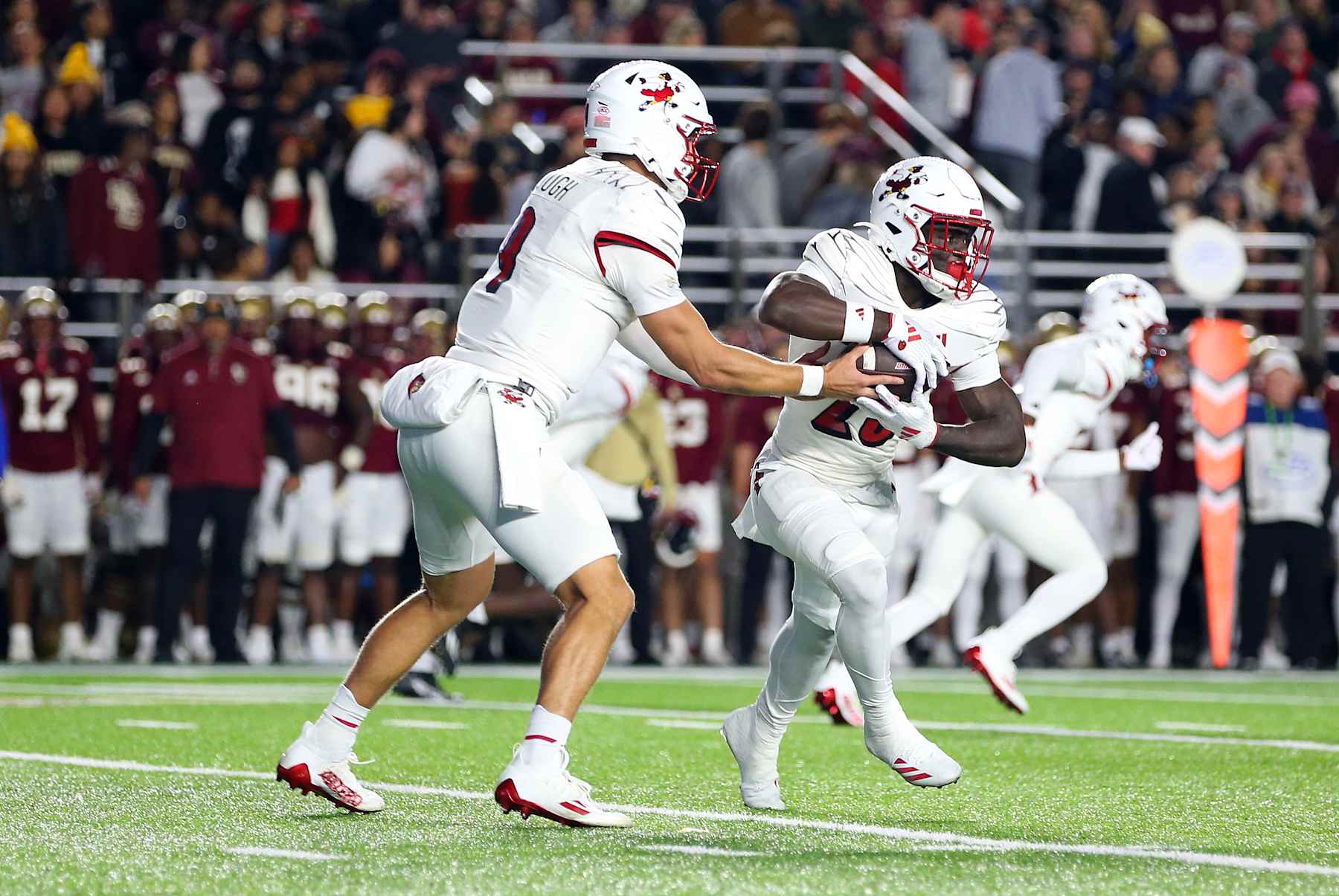 CHESTNUT HILL, MA - OCTOBER 25: Louisville Cardinals quarterback Tyler Shough (9) hands off to Louisville Cardinals running back Isaac Brown (25) during a college football game between Louisville Cardinals and Boston College Eagles on October 25, 2024, at Alumni Stadium in Chestnut Hill, MA. (Photo by M. Anthony Nesmith/Icon Sportswire via Getty Images)