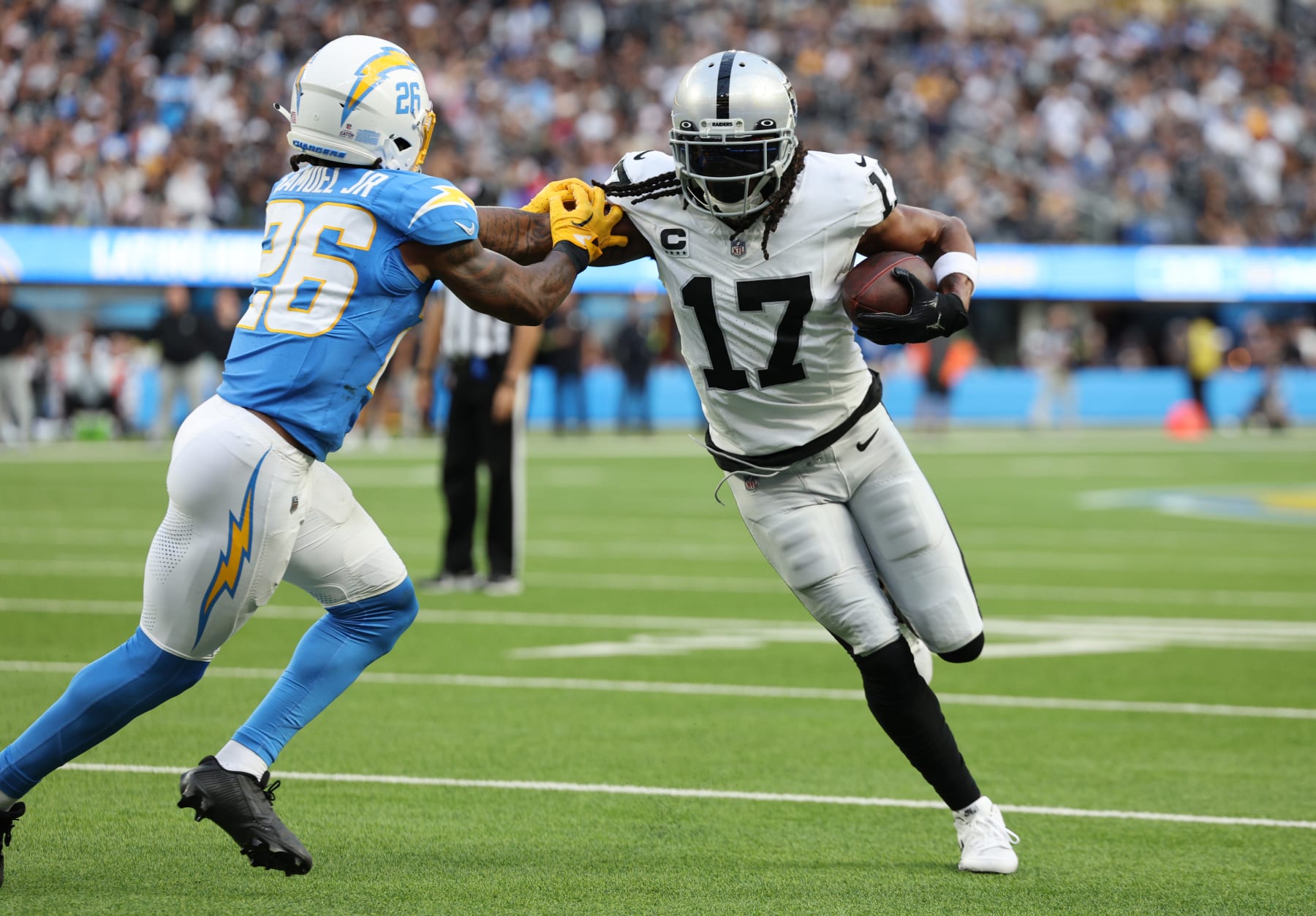 INGLEWOOD, CALIFORNIA - OCTOBER 01: Davante Adams #17 of the Las Vegas Raiders runs against Asante Samuel Jr. #26 of the Los Angeles Chargers during the third quarter at SoFi Stadium on October 01, 2023 in Inglewood, California. (Photo by Kevork Djansezian/Getty Images)