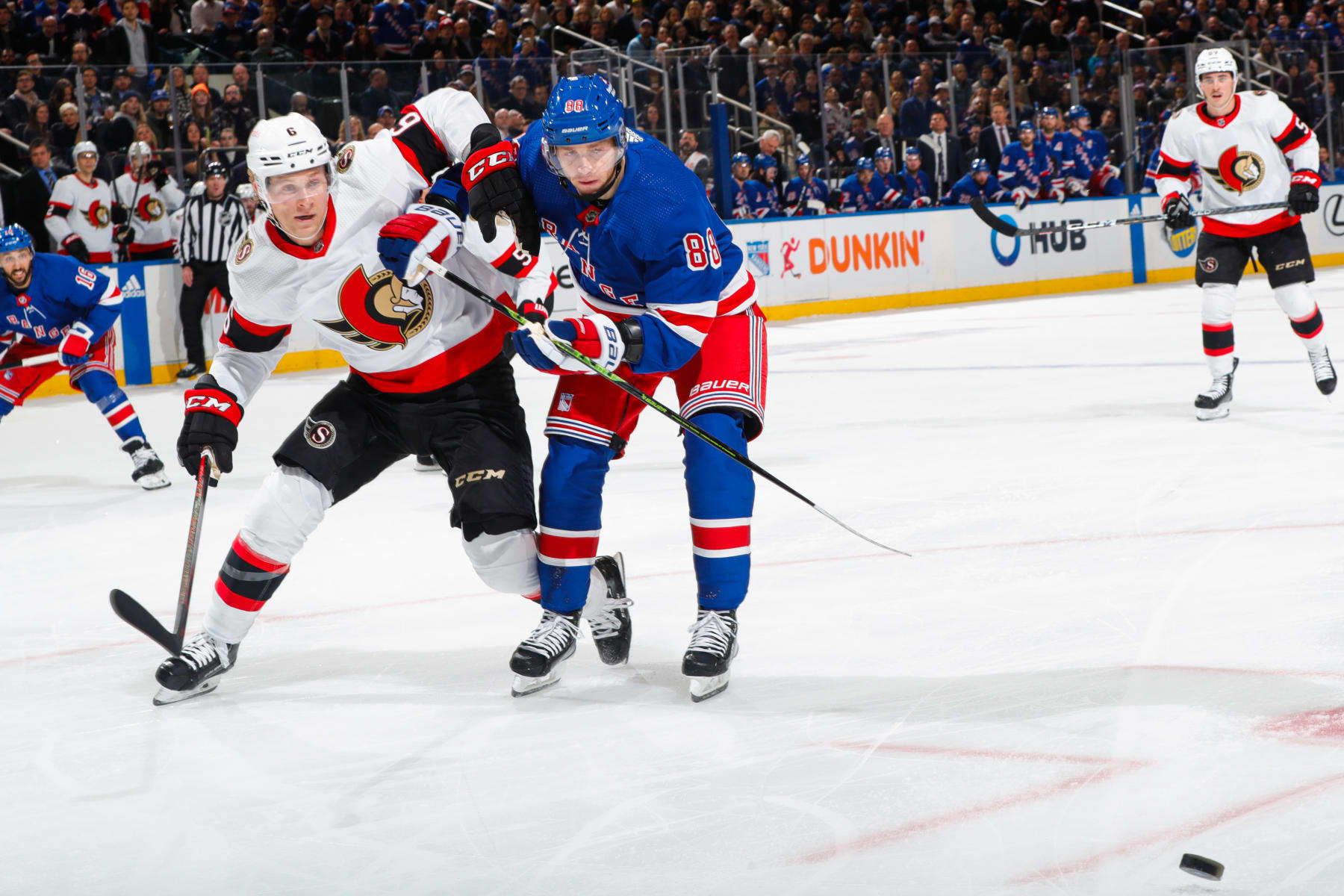 Ottawa Senators defenseman Jakob Chychrun (left) and New York Rangers winger Patrick Kane battle for the puck.