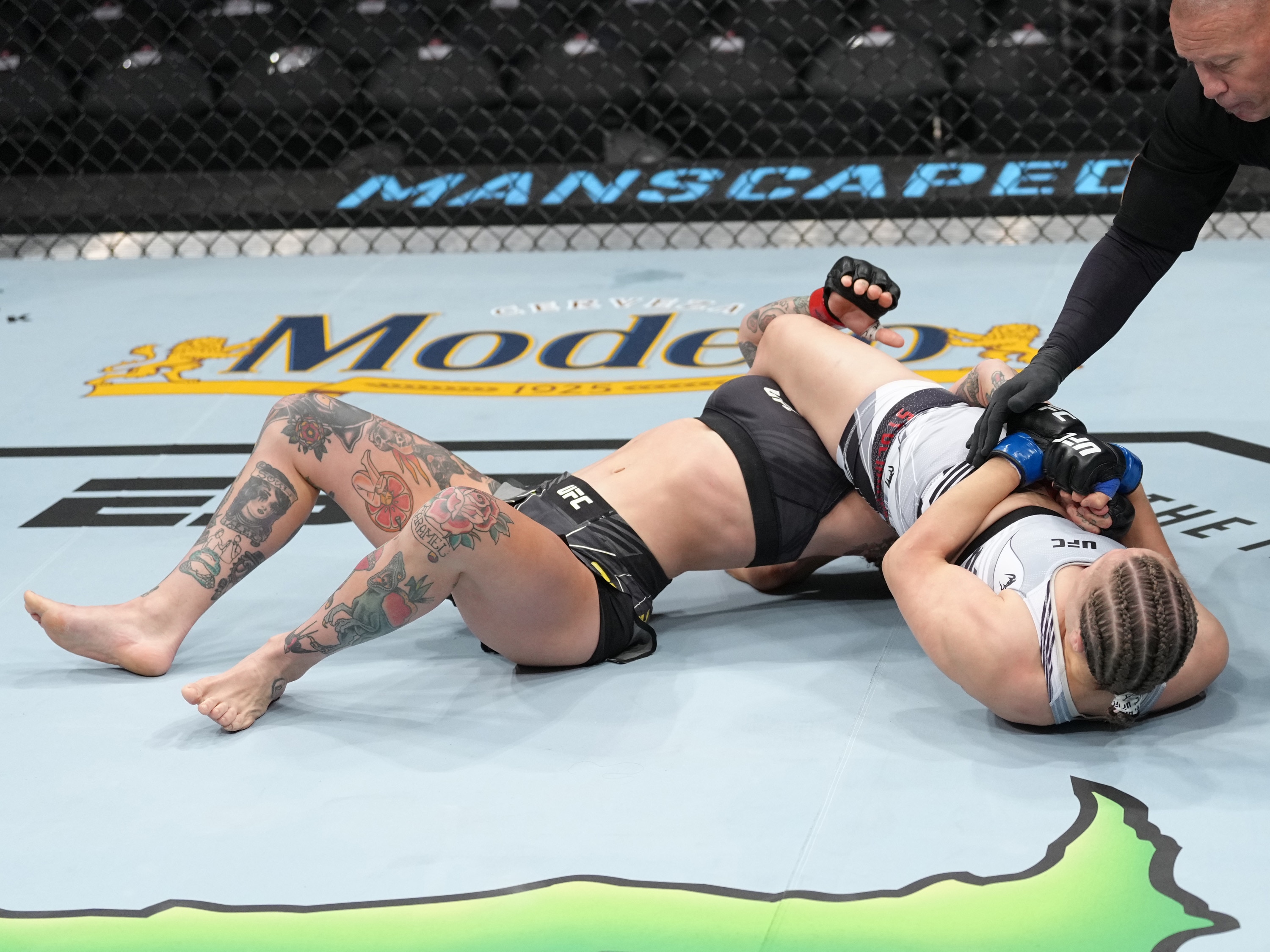 LAS VEGAS, NEVADA - JULY 02: Julija Stoliarenko of Lithuania armbars Jessica-Rose Clark of Australia in a bantamweight fight during the UFC 276 event at T-Mobile Arena on July 02, 2022 in Las Vegas, Nevada. (Photo by Jeff Bottari/Zuffa LLC)