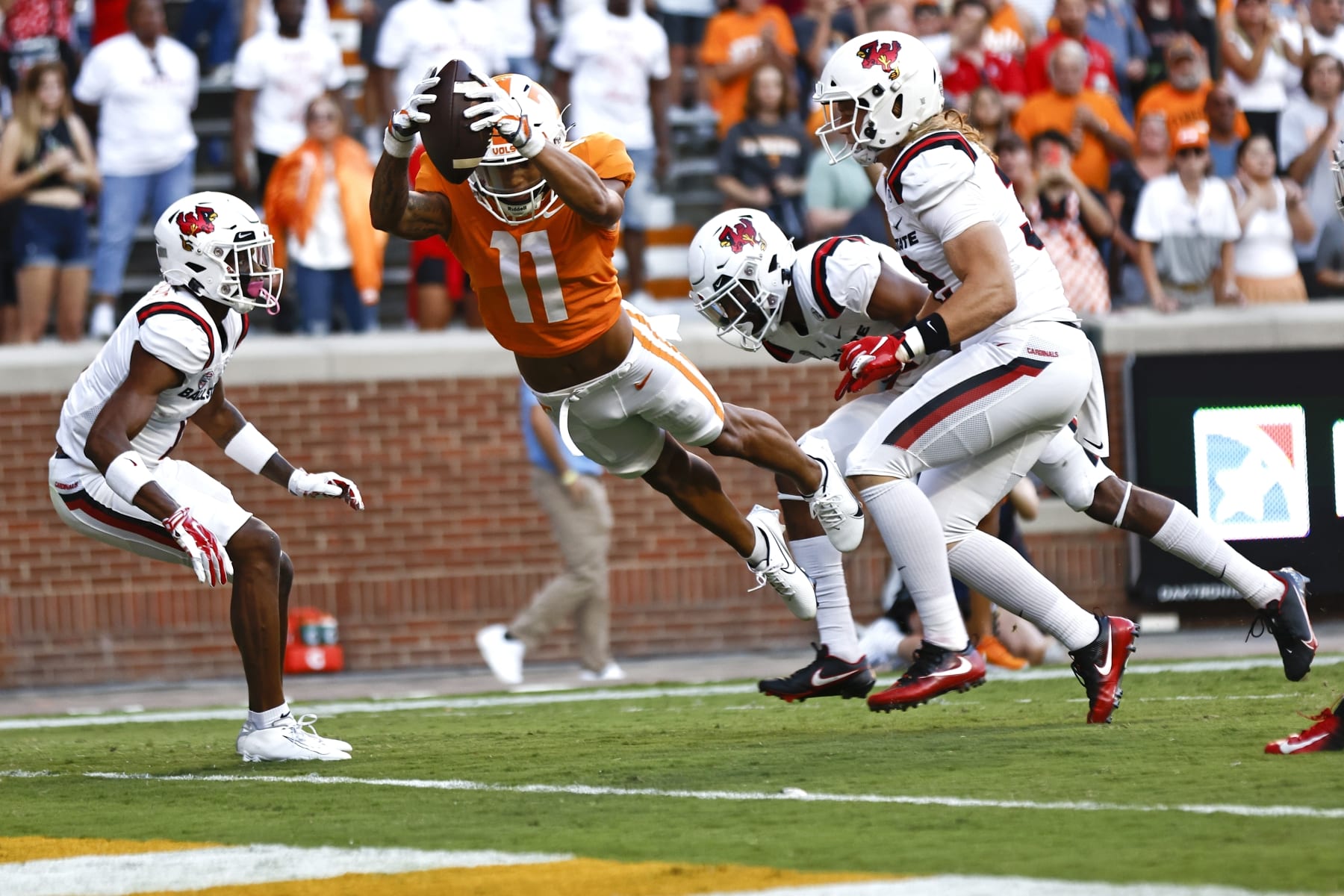 Tennessee wide receiver Jalin Hyatt (11) dives into the end zone between Ball State defenders for a touchdown during the first half of an NCAA college football game Thursday, Sept. 1, 2022, in Knoxville, Tenn. (AP Photo/Wade Payne)