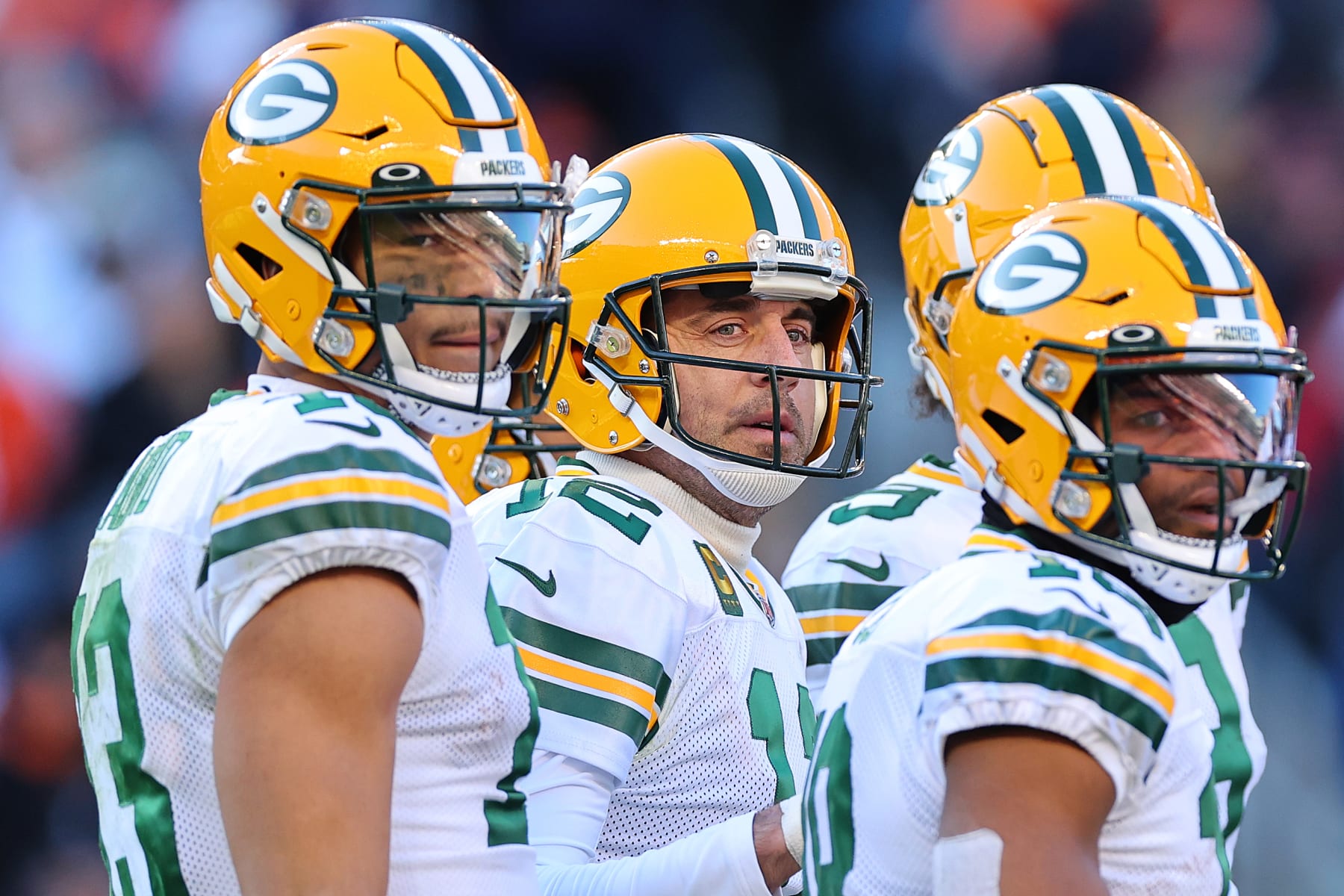 CHICAGO, ILLINOIS - DECEMBER 04: Allen Lazard #13, Aaron Rodgers #12 and Randall Cobb #18 of the Green Bay Packers look on against the Chicago Bears at Soldier Field on December 04, 2022 in Chicago, Illinois. (Photo by Michael Reaves/Getty Images)