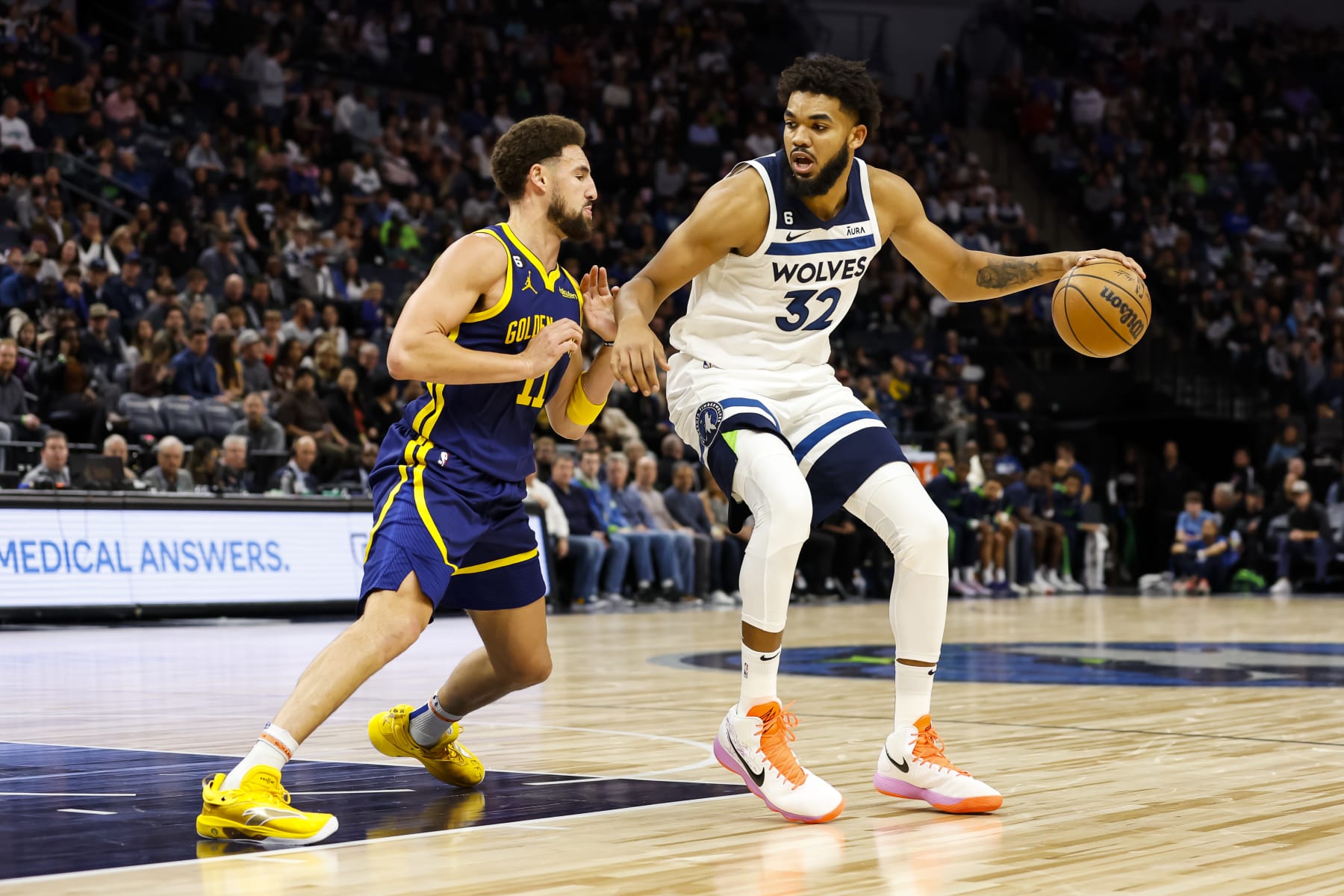 MINNEAPOLIS, MN - NOVEMBER 27: Karl-Anthony Towns #32 of the Minnesota Timberwolves dribbles the ball while Klay Thompson #11 of the Golden State Warriors defends in the third quarter of the game at Target Center on November 27, 2022 in Minneapolis, Minnesota. The Warriors defeated the Timberwolves 137-114. NOTE TO USER: User expressly acknowledges and agrees that, by downloading and or using this Photograph, user is consenting to the terms and conditions of the Getty Images License Agreement. (Photo by David Berding/Getty Images)