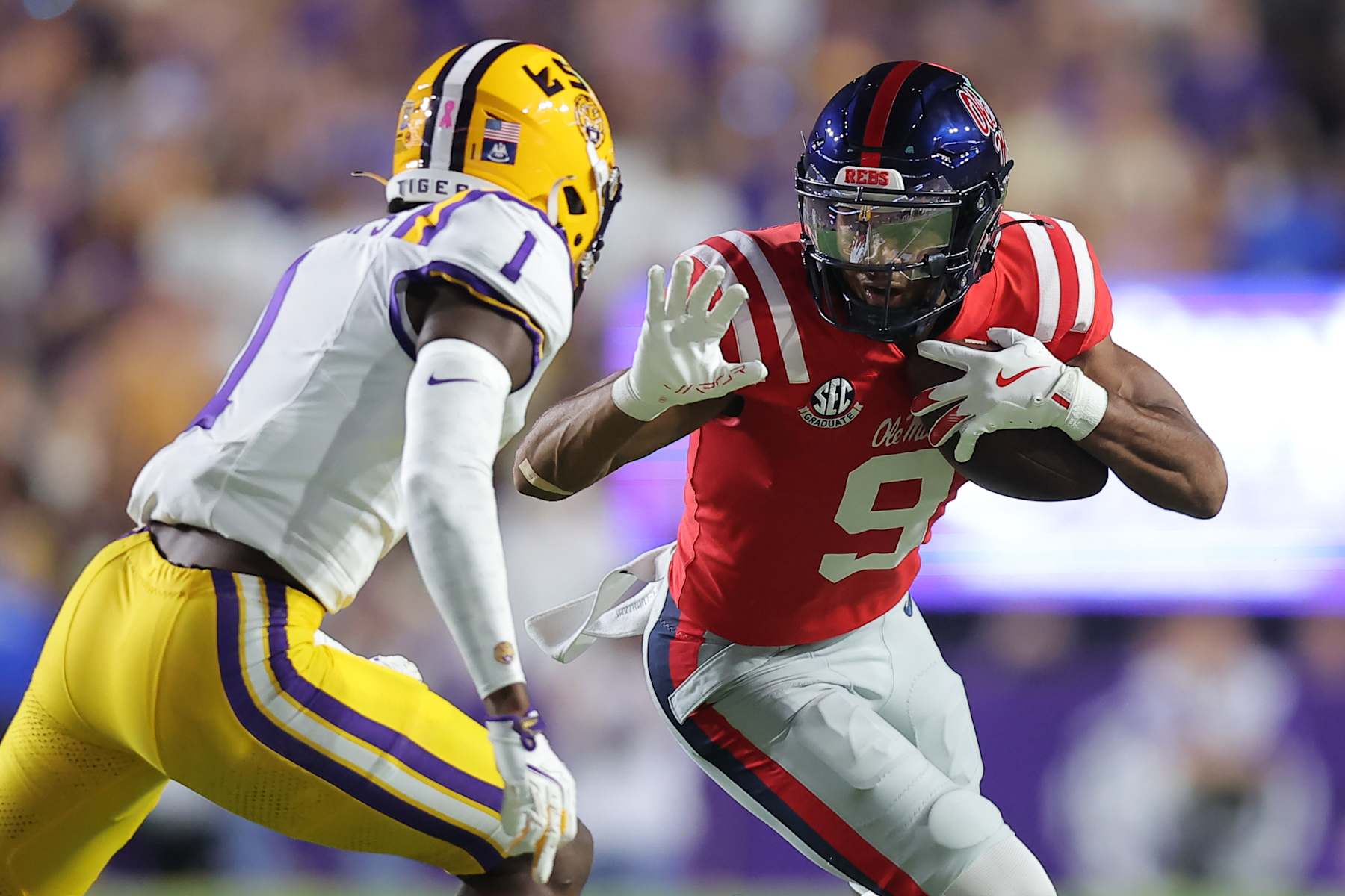BATON ROUGE, LOUISIANA - OCTOBER 12: Tre Harris #9 of the Mississippi Rebels runs with the ball as Ashton Stamps #1 of the LSU Tigers defends during the first half of a game at Tiger Stadium on October 12, 2024 in Baton Rouge, Louisiana. (Photo by Jonathan Bachman/Getty Images)