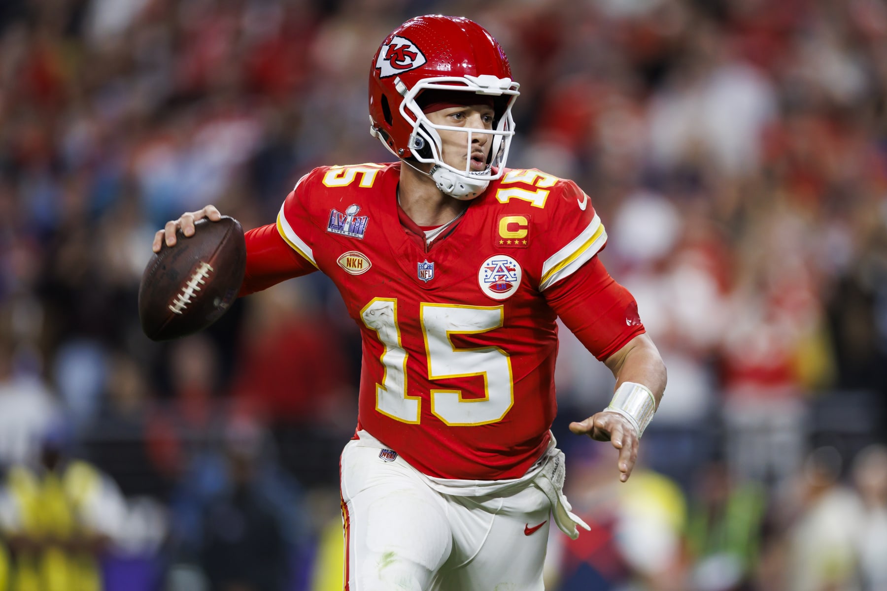 LAS VEGAS, NEVADA - FEBRUARY 11: Patrick Mahomes #15 of the Kansas City Chiefs rolls out and looks to throw a pass to Mecole Hardman Jr. to score the game-winning touchdown during Super Bowl LVIII against the San Francisco 49ers at Allegiant Stadium on February 11, 2024 in Las Vegas, Nevada. (Photo by Ryan Kang/Getty Images)