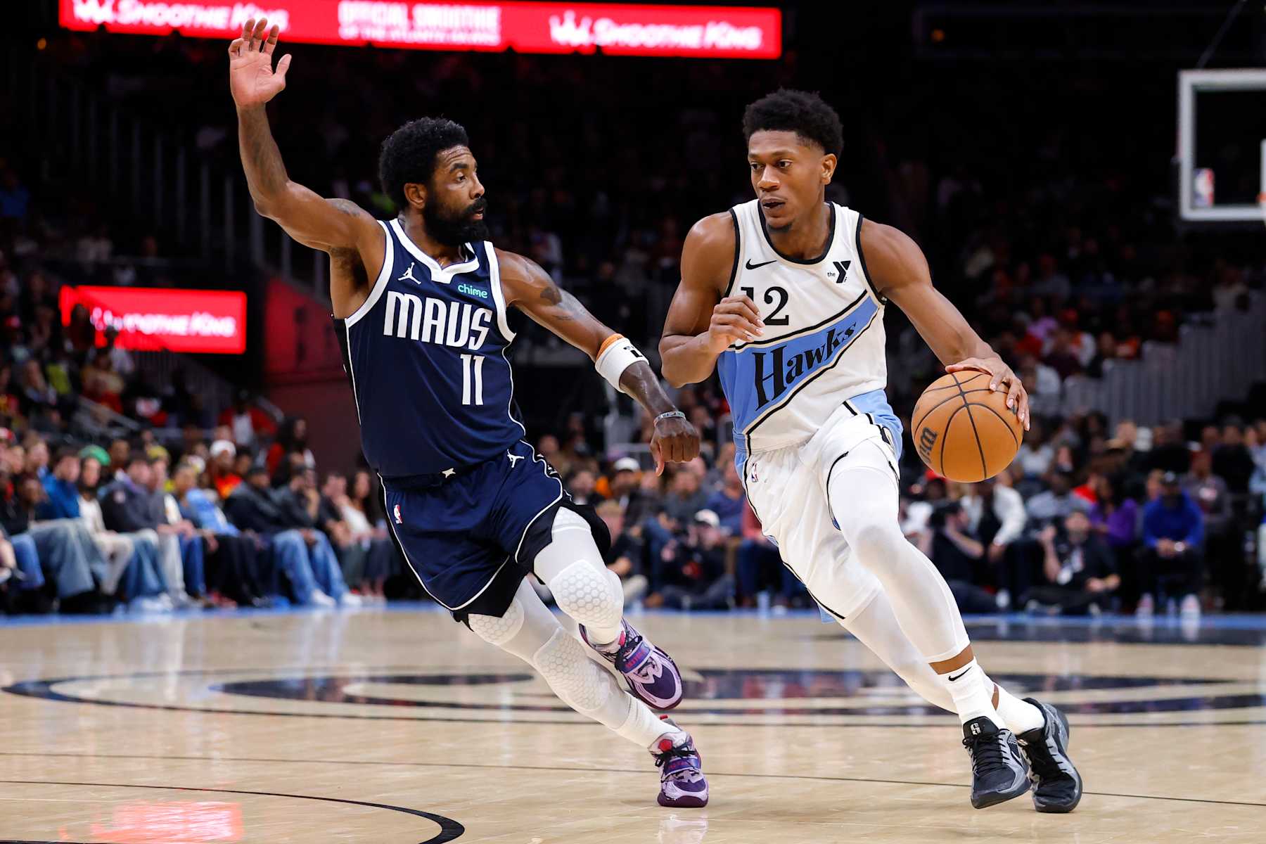 ATLANTA, GEORGIA - NOVEMBER 25: De'Andre Hunter #12 of the Atlanta Hawks drives against Kyrie Irving #11 of the Dallas Mavericks during the third quarter at State Farm Arena on November 25, 2024 in Atlanta, Georgia. NOTE TO USER: User expressly acknowledges and agrees that, by downloading and or using this photograph, User is consenting to the terms and conditions of the Getty Images License Agreement. (Photo by Todd Kirkland/Getty Images)
