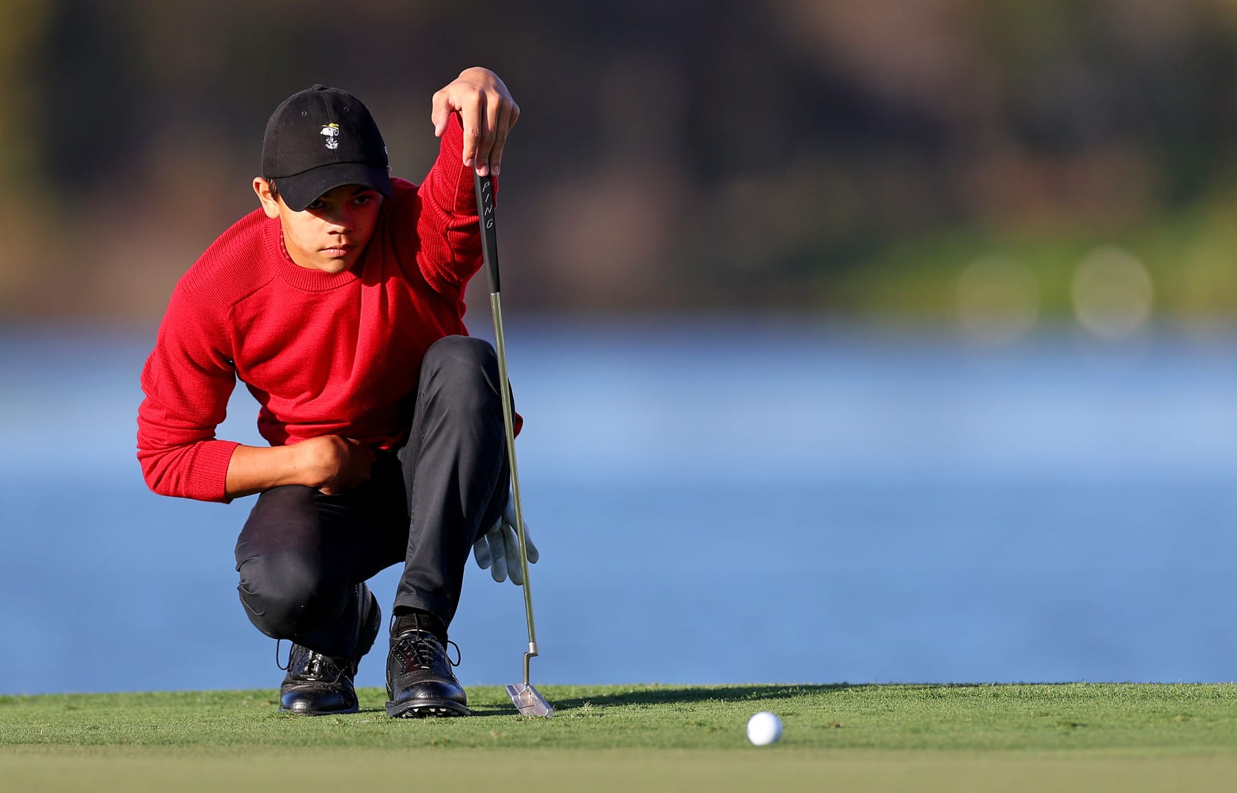 ORLANDO, FLORIDA - DECEMBER 18:  Charlie Woods lines up a putt on the 18th hole during the final round of the PNC Championship at Ritz-Carlton Golf Club on December 18, 2022 in Orlando, Florida. (Photo by Mike Ehrmann/Getty Images)