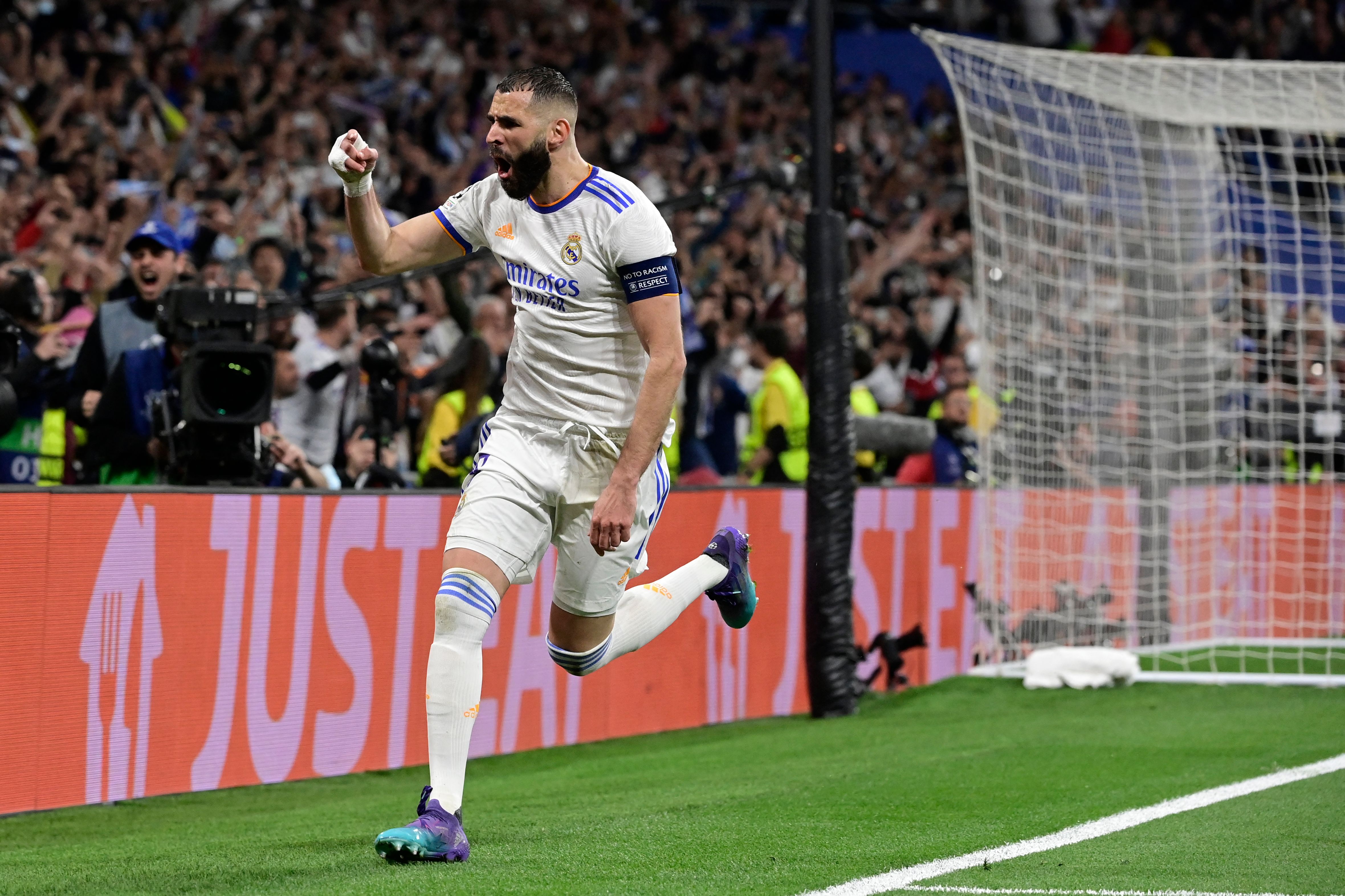 Real Madrid's French forward Karim Benzema celebrates scoring his team's third goal during the UEFA Champions League semi-final second leg football match between Real Madrid CF and Manchester City at the Santiago Bernabeu stadium in Madrid on May 4, 2022. (Photo by JAVIER SORIANO / AFP) (Photo by JAVIER SORIANO/AFP via Getty Images)