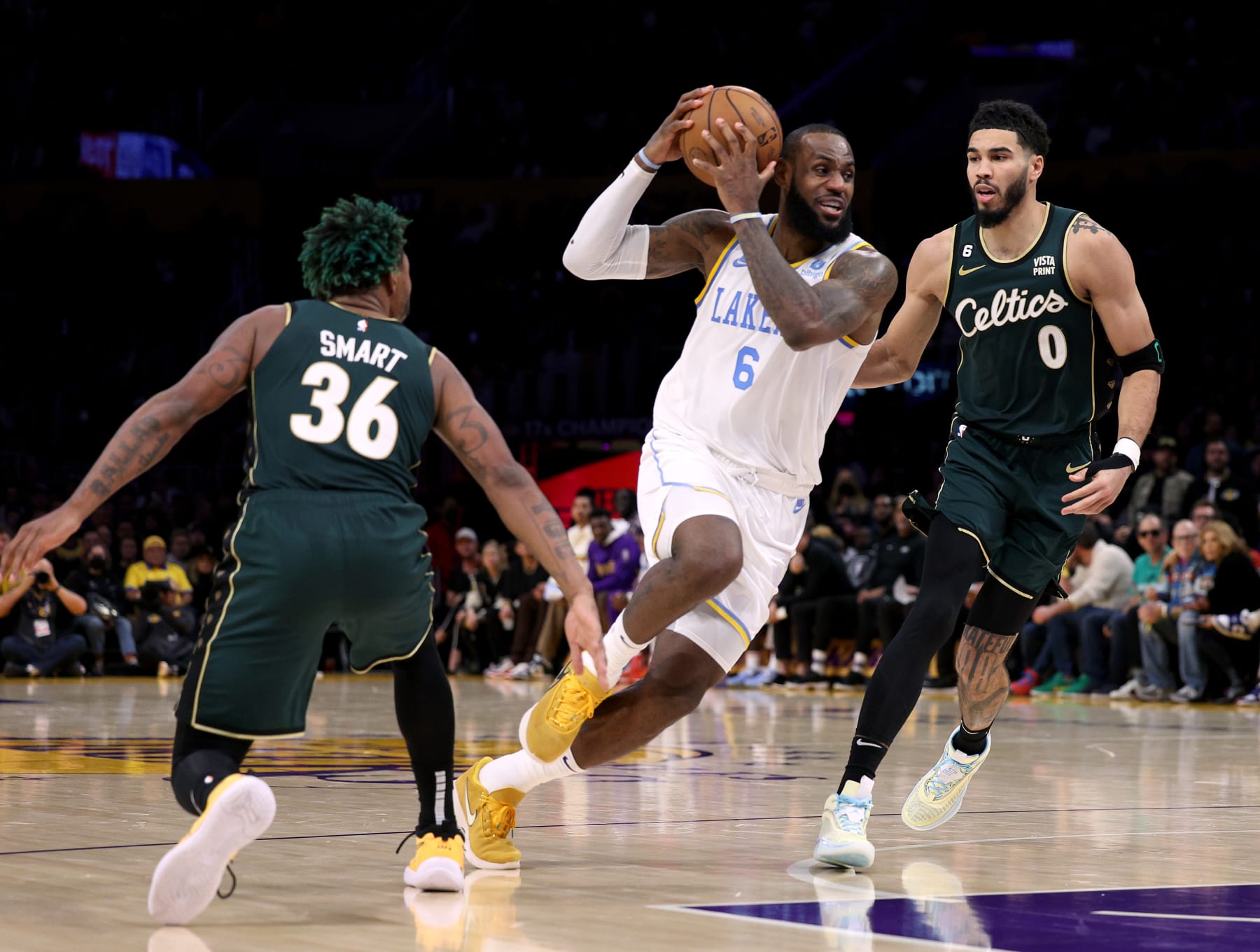 LOS ANGELES, CALIFORNIA - DECEMBER 13: LeBron James #6 of the Los Angeles Lakers drives between Jayson Tatum #0 and Marcus Smart #36 of the Boston Celtics during a 122-118 loss to the Celtics at Crypto.com Arena on December 13, 2022 in Los Angeles, California. NOTE TO USER: User expressly acknowledges and agrees that, by downloading and/or using this photograph, User is consenting to the terms and conditions of the Getty Images License Agreement. Mandatory Copyright Notice: Copyright 2022 NBAE. (Photo by Harry How/Getty Images)