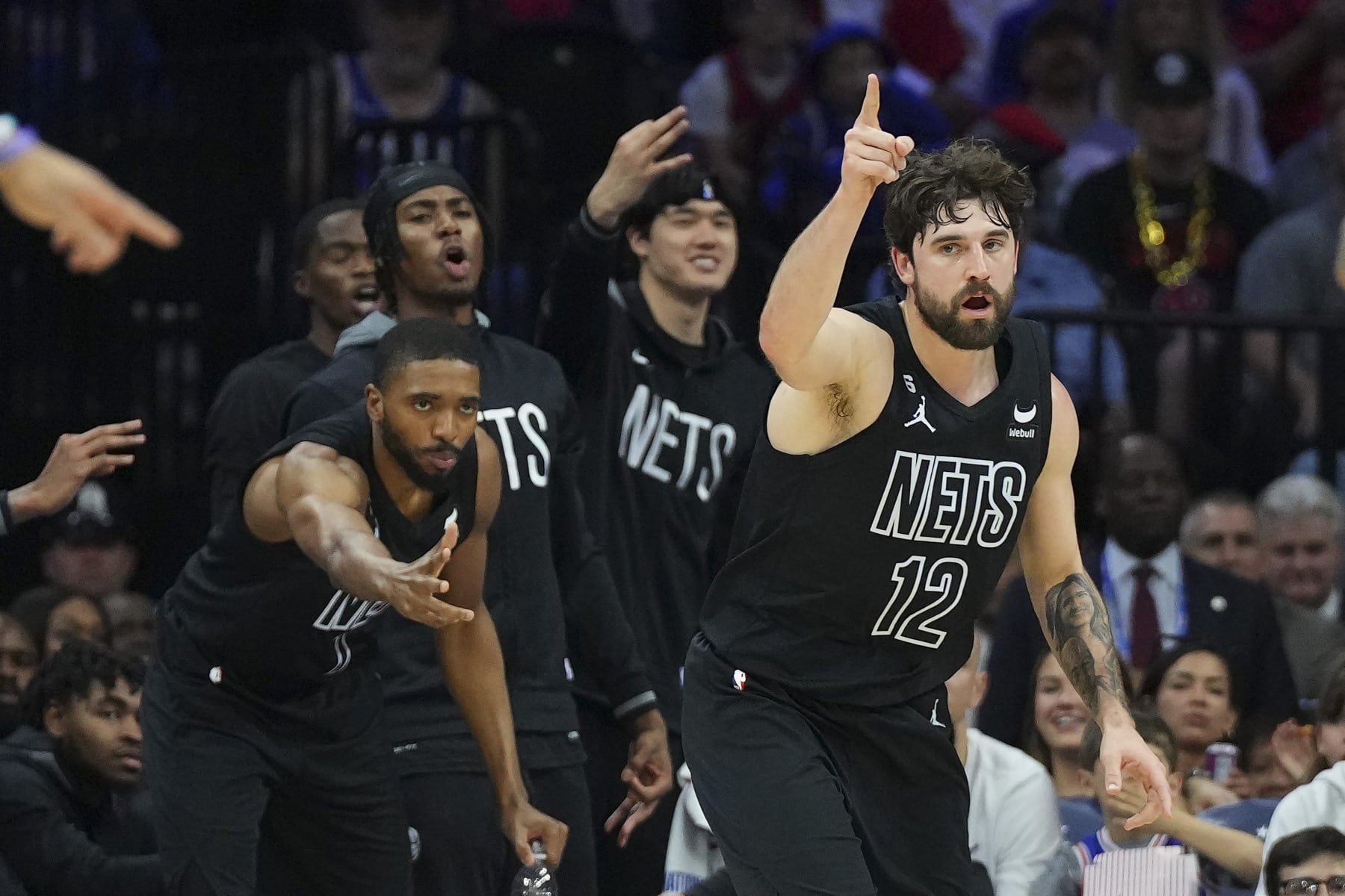 PHILADELPHIA, PA - APRIL 15: Joe Harris #12 and Mikal Bridges #1 of the Brooklyn Nets react against the Philadelphia 76ers during Game One of the Eastern Conference First Round Playoffs at the Wells Fargo Center on April 15, 2023 in Philadelphia, Pennsylvania. The 76ers defeated the Nets 121-101. NOTE TO USER: User expressly acknowledges and agrees that, by downloading and or using this photograph, User is consenting to the terms and conditions of the Getty Images License Agreement. (Photo by Mitchell Leff/Getty Images)