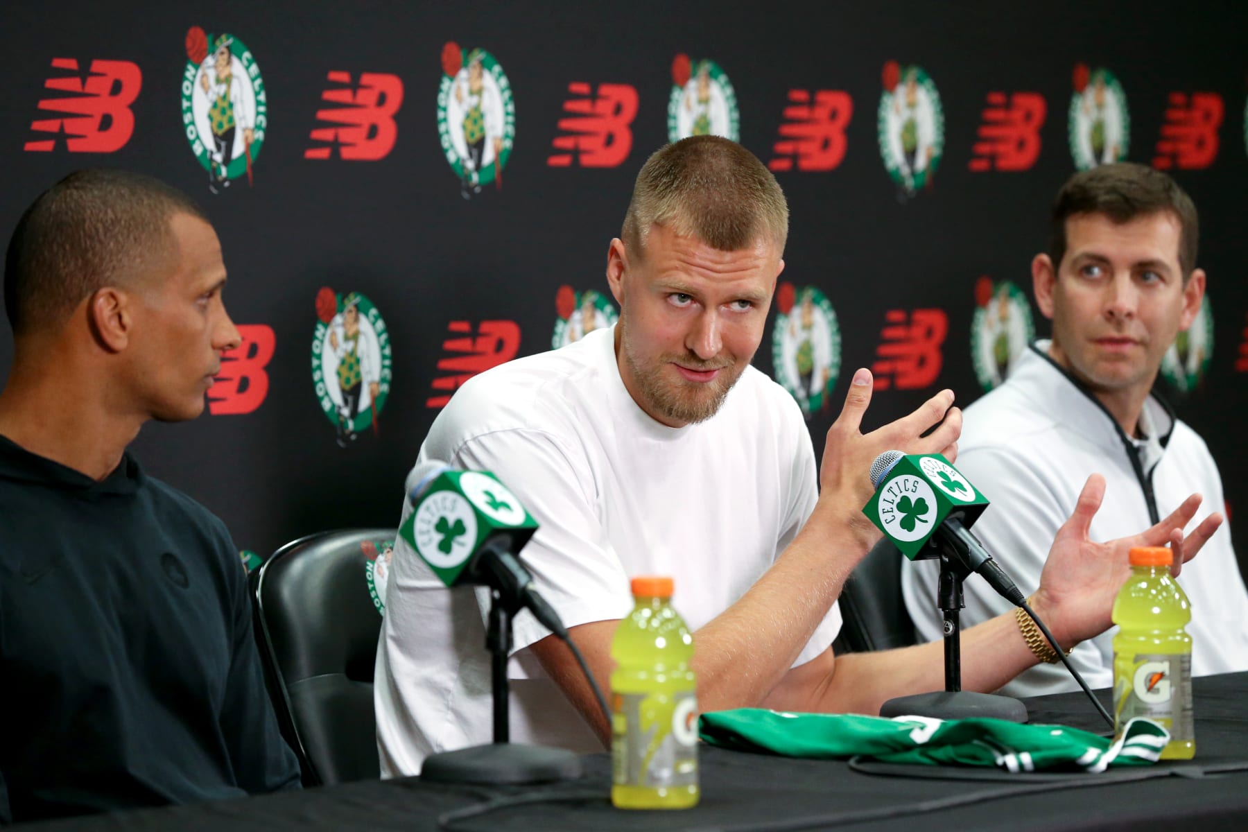 Boston, MA - June 29: Boston Celtics C Kristaps Porzingis speaks at his introductory press conference, flanked by head coach Joe Mazzulla and President of Basketball Operations Brad Stevens. (Photo by Jonathan Wiggs/The Boston Globe via Getty Images)