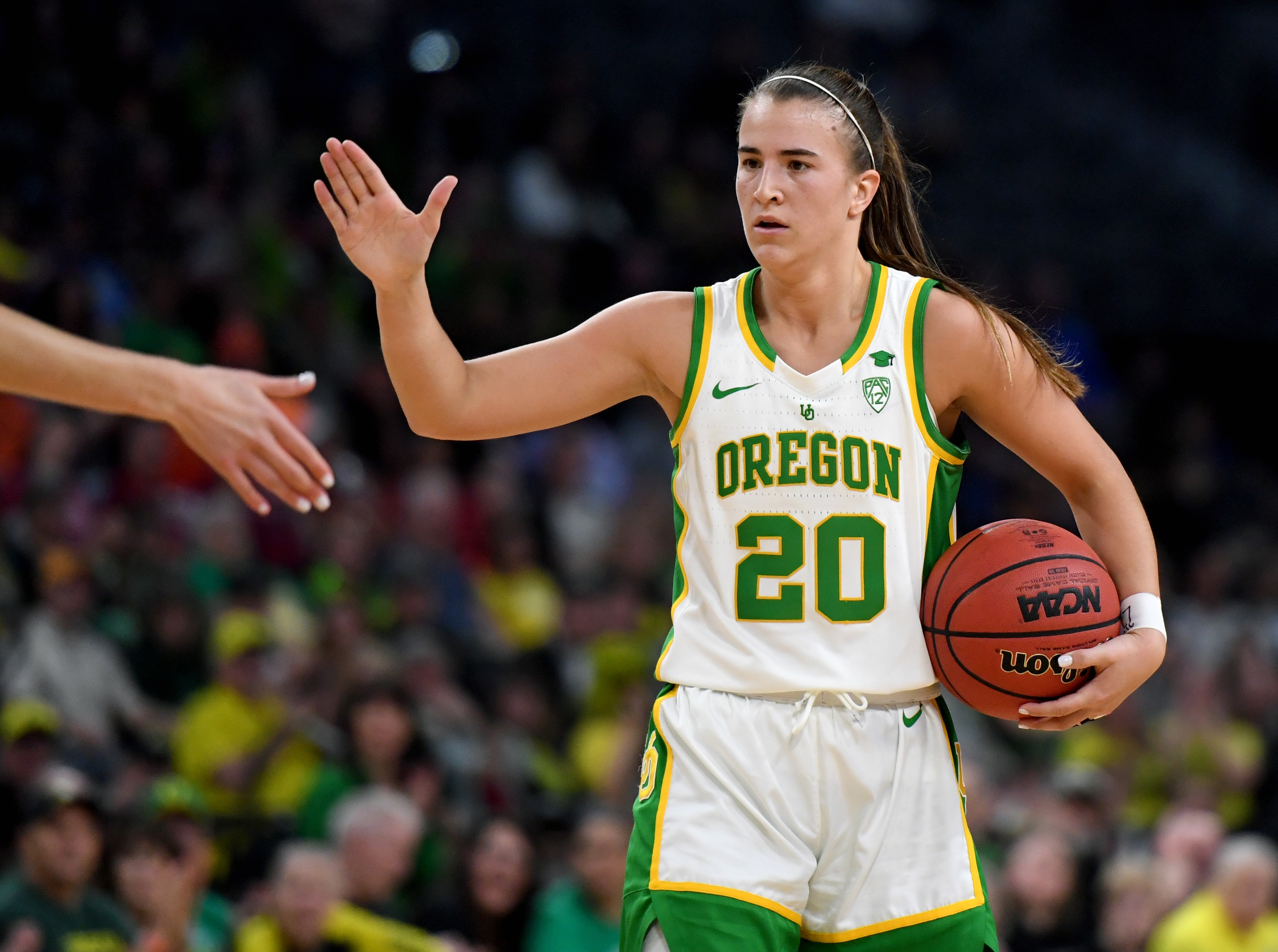 LAS VEGAS, NEVADA - MARCH 08:  Sabrina Ionescu #20 of the Oregon Ducks high-fives a teammate as they take on the Stanford Cardinal during the championship game of the Pac-12 Conference women's basketball tournament at the Mandalay Bay Events Center on March 8, 2020 in Las Vegas, Nevada. The Ducks defeated the Cardinal 89-56.  (Photo by Ethan Miller/Getty Images)