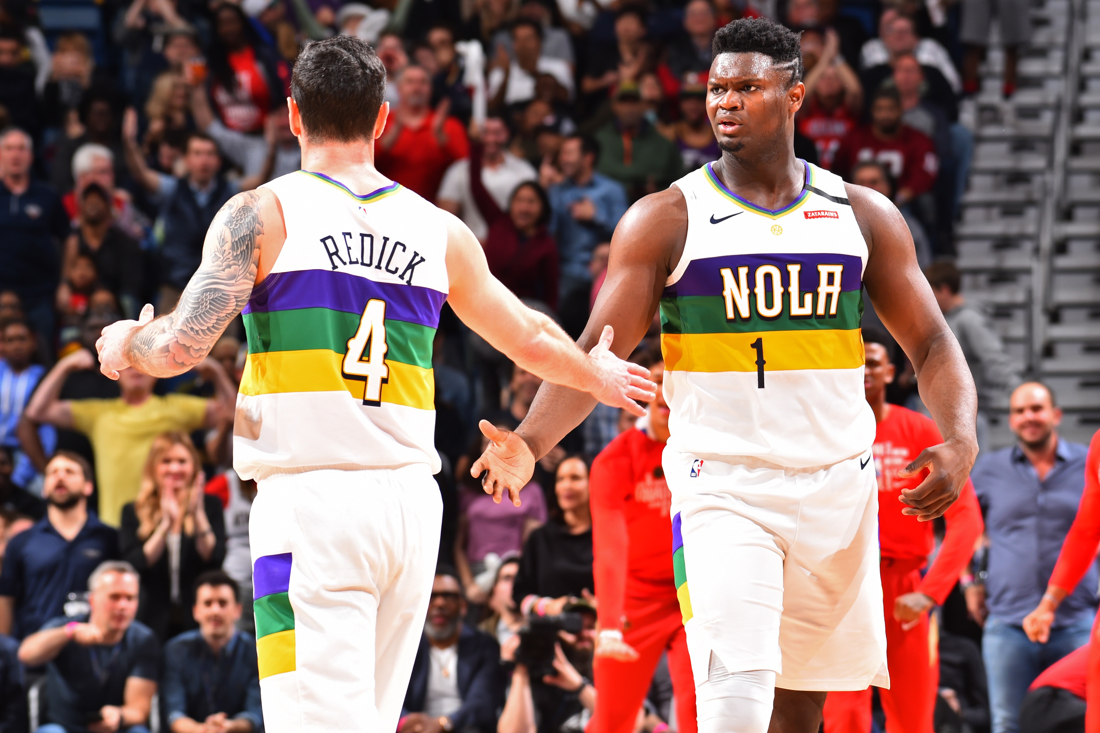 NEW ORLEANS, LA - FEBRUARY 4: JJ Redick #4 of the New Orleans Pelicans high-fives Zion Williamson #1 of the New Orleans Pelicans against the Milwaukee Bucks on February 4, 2020 at the Smoothie King Center in New Orleans, Louisiana. NOTE TO USER: User expressly acknowledges and agrees that, by downloading and or using this Photograph, user is consenting to the terms and conditions of the Getty Images License Agreement. Mandatory Copyright Notice: Copyright 2020 NBAE (Photo by Jesse D. Garrabrant/NBAE via Getty Images)
