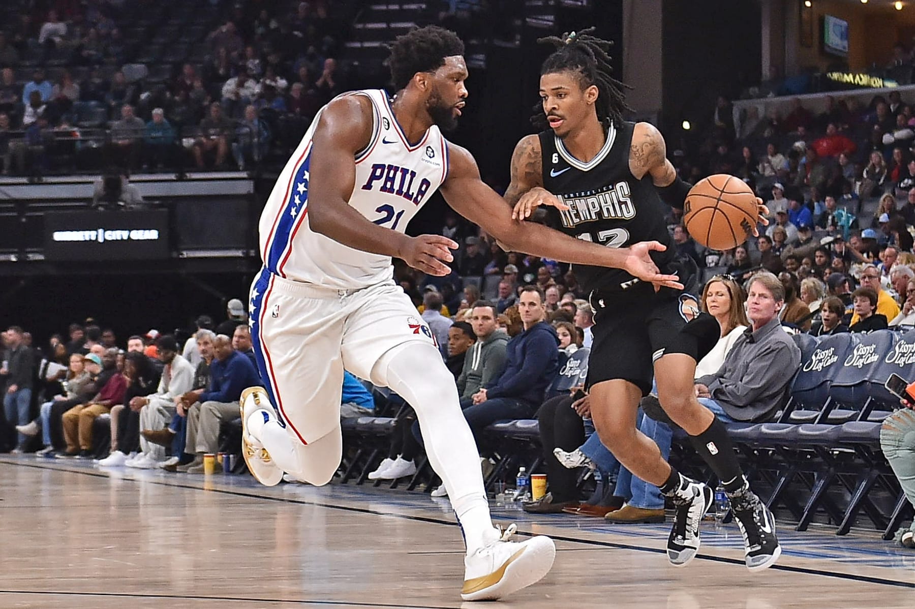 MEMPHIS, TENNESSEE - DECEMBER 02: Ja Morant #12 of the Memphis Grizzlies handles the ball during the second half against Joel Embiid #21 of the Philadelphia 76ers at FedExForum on December 02, 2022 in Memphis, Tennessee. NOTE TO USER: User expressly acknowledges and agrees that, by downloading and or using this photograph, User is consenting to the terms and conditions of the Getty Images License Agreement. (Photo by Justin Ford/Getty Images)