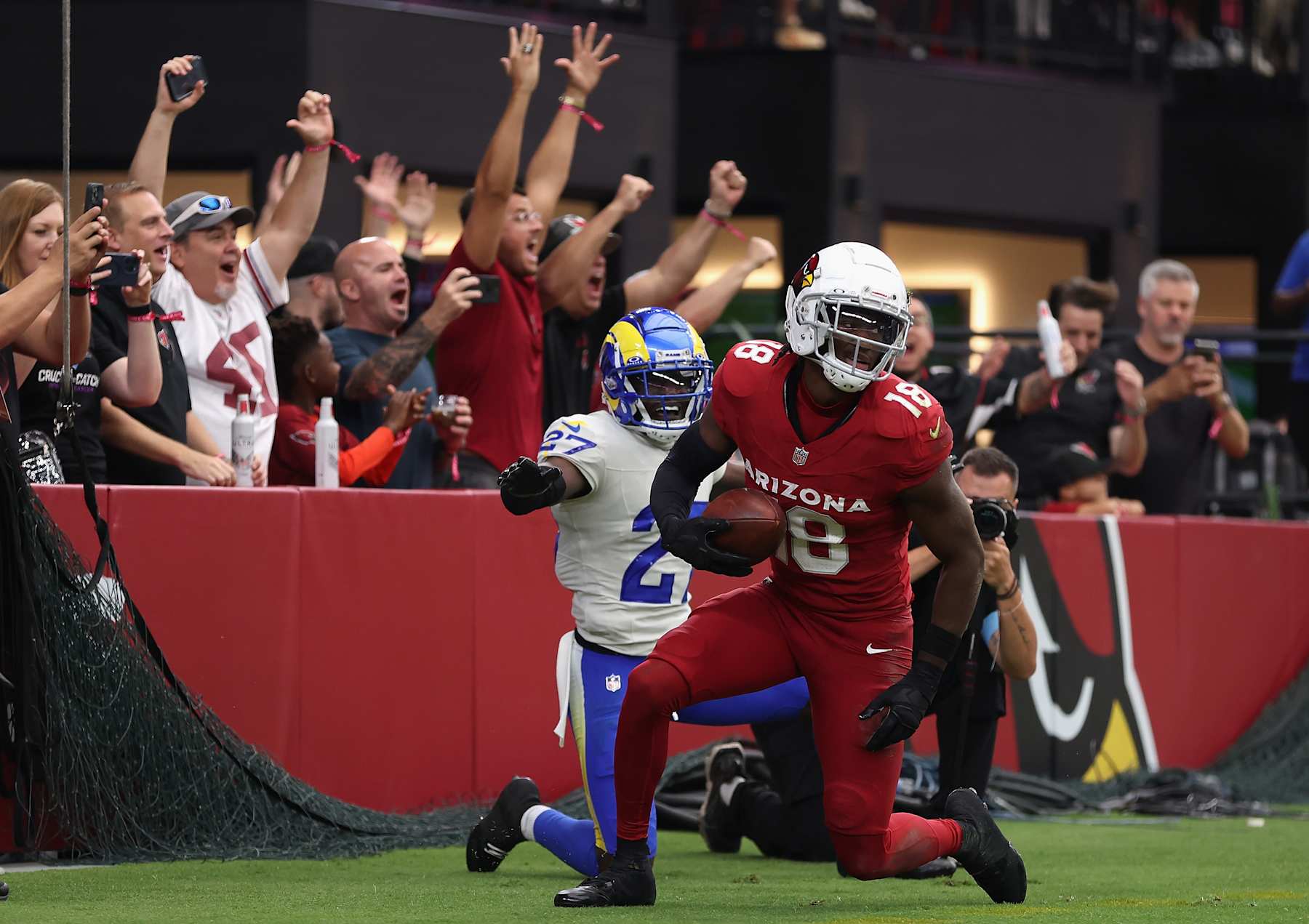 GLENDALE, ARIZONA - SEPTEMBER 15: Wide receiver Marvin Harrison Jr. #18 of the Arizona Cardinals reacts after scoring his first career touchdown reception against Tre'Davious White #27 of the Los Angeles Rams during the first half of the NFL game at State Farm Stadium on September 15, 2024 in Glendale, Arizona. The Cardinals defeated the Rams 41-10. (Photo by Christian Petersen/Getty Images)