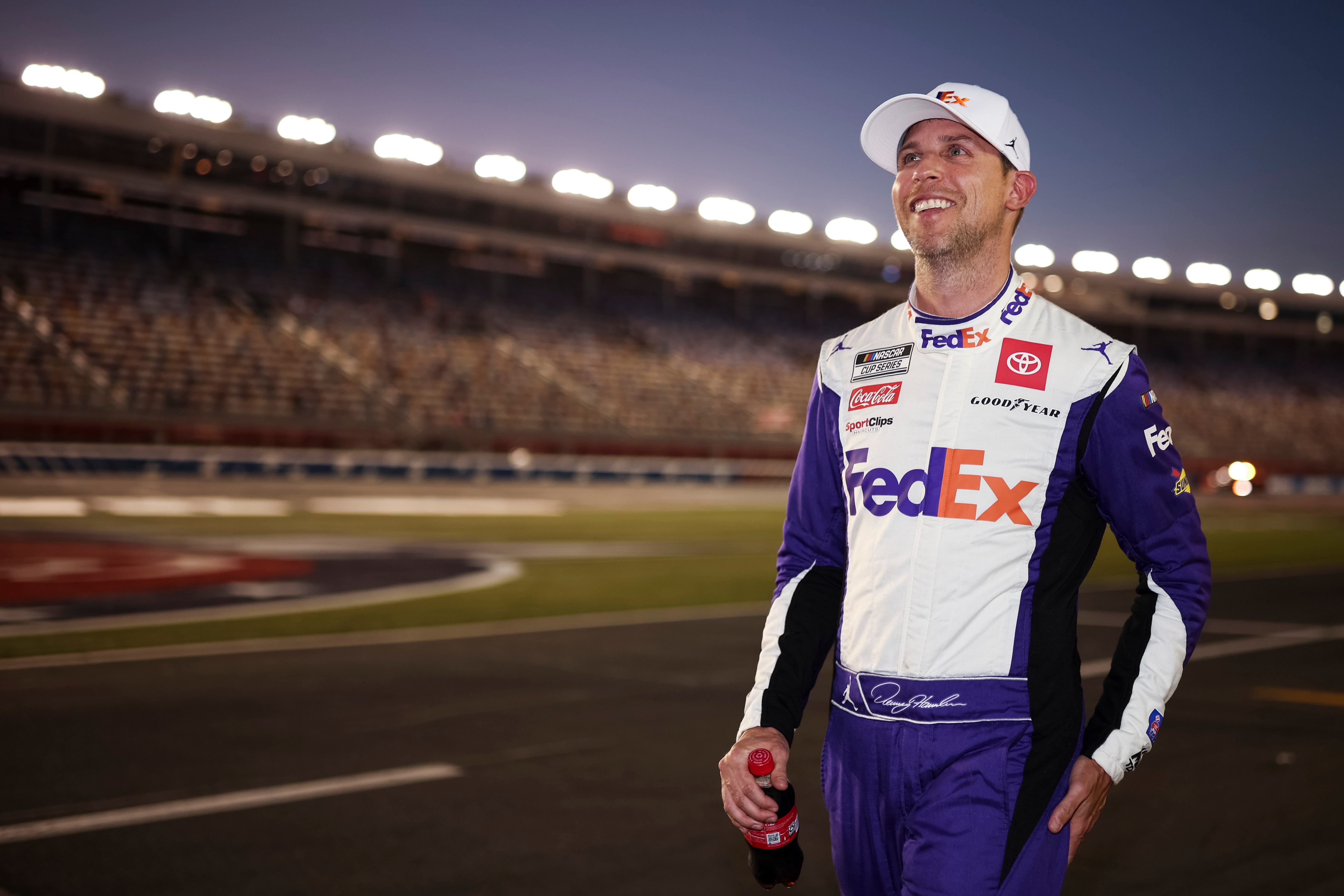 CONCORD, NORTH CAROLINA - MAY 28: Denny Hamlin, driver of the #11 FedEx Ground Toyota, reacts after winning the pole award during qualifying for the NASCAR Cup Series Coca-Cola 600 at Charlotte Motor Speedway on May 28, 2022 in Concord, North Carolina. (Photo by James Gilbert/Getty Images)
