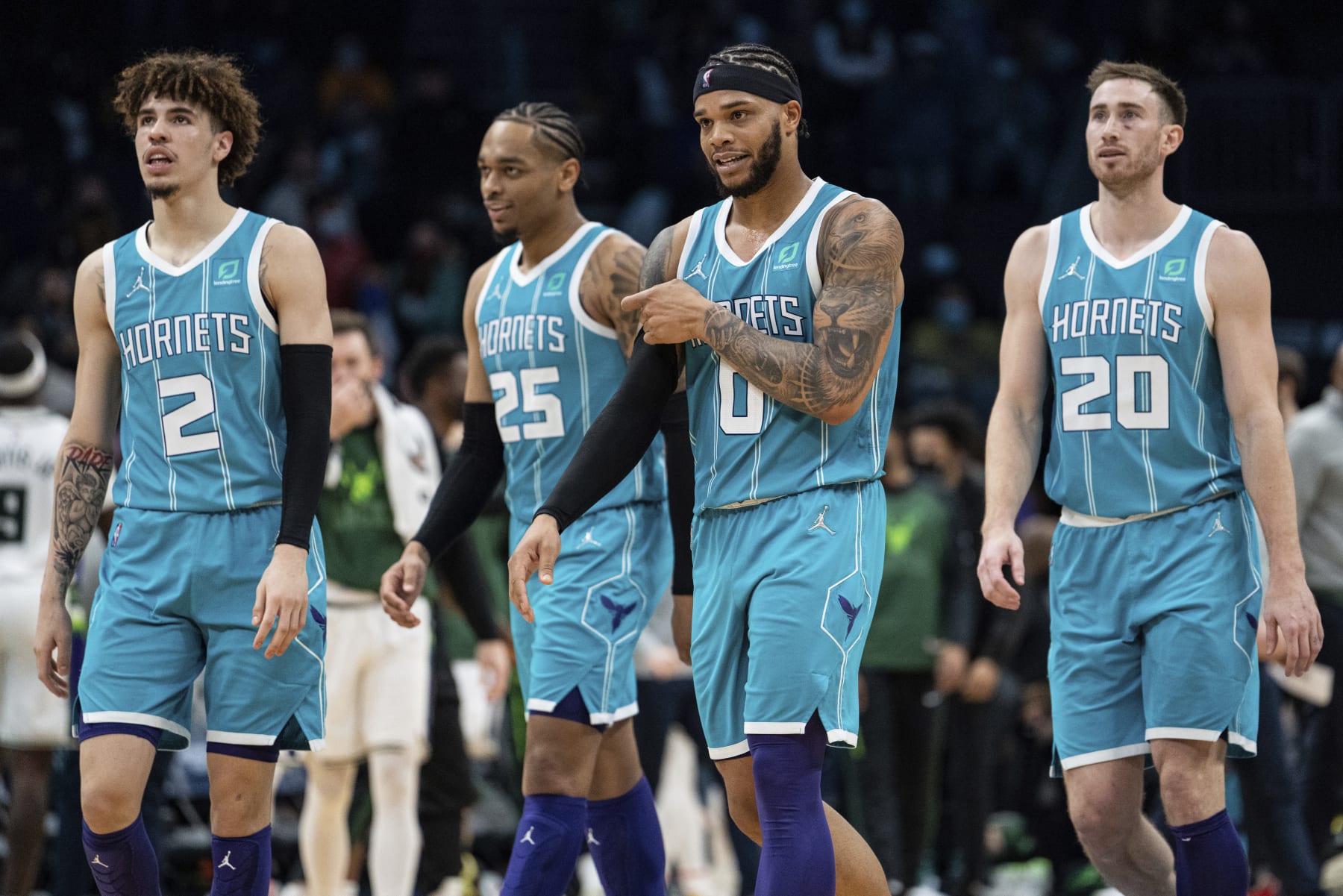 From left to right, Charlotte Hornets guard LaMelo Ball, forwards P.J. Washington, Miles Bridges and Gordon Hayward walk to the bench during the second half of an NBA basketball game against the Milwaukee Bucks in Charlotte, N.C., Monday, Jan. 10, 2022. (AP Photo/Jacob Kupferman)