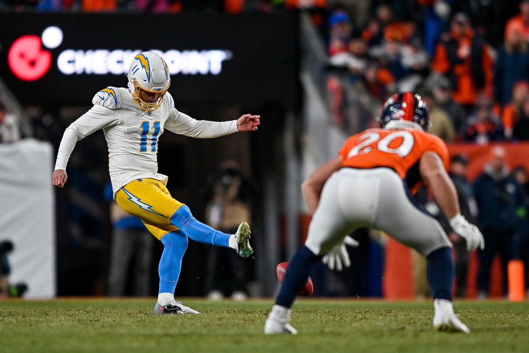 DENVER, COLORADO - DECEMBER 31:  Place kicker Cameron Dicker #11 of the Los Angeles Chargers attempts an onside kick against the Denver Broncos in the fourth quarter at Empower Field at Mile High on December 31, 2023 in Denver, Colorado. (Photo by Dustin Bradford/Getty Images)