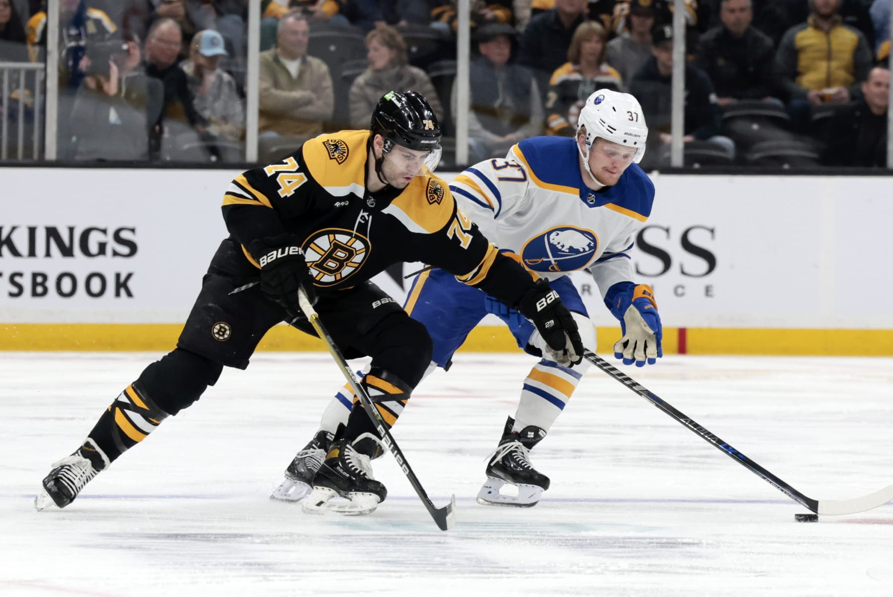 BOSTON, MA - MARCH 02: Boston Bruins left wing Jake DeBrusk (74) moves in on Buffalo Sabres winger Casey Mittelstadt (37) during a game between the Boston Bruins and the Buffalo Sabres on March 2, 2023, at TD Garden in Boston, Massachusetts. (Photo by Fred Kfoury III/Icon Sportswire via Getty Images)