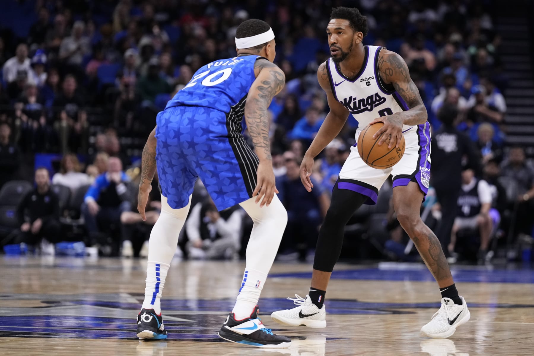 ORLANDO, FLORIDA - MARCH 23: Malik Monk #0 of the Sacramento Kings dribbles the ball against Markelle Fultz #20 of the Orlando Magic during the first quarter at Kia Center on March 23, 2024 in Orlando, Florida. NOTE TO USER: User expressly acknowledges and agrees that, by downloading and or using this photograph, User is consenting to the terms and conditions of the Getty Images License Agreement. (Photo by Rich Storry/Getty Images)