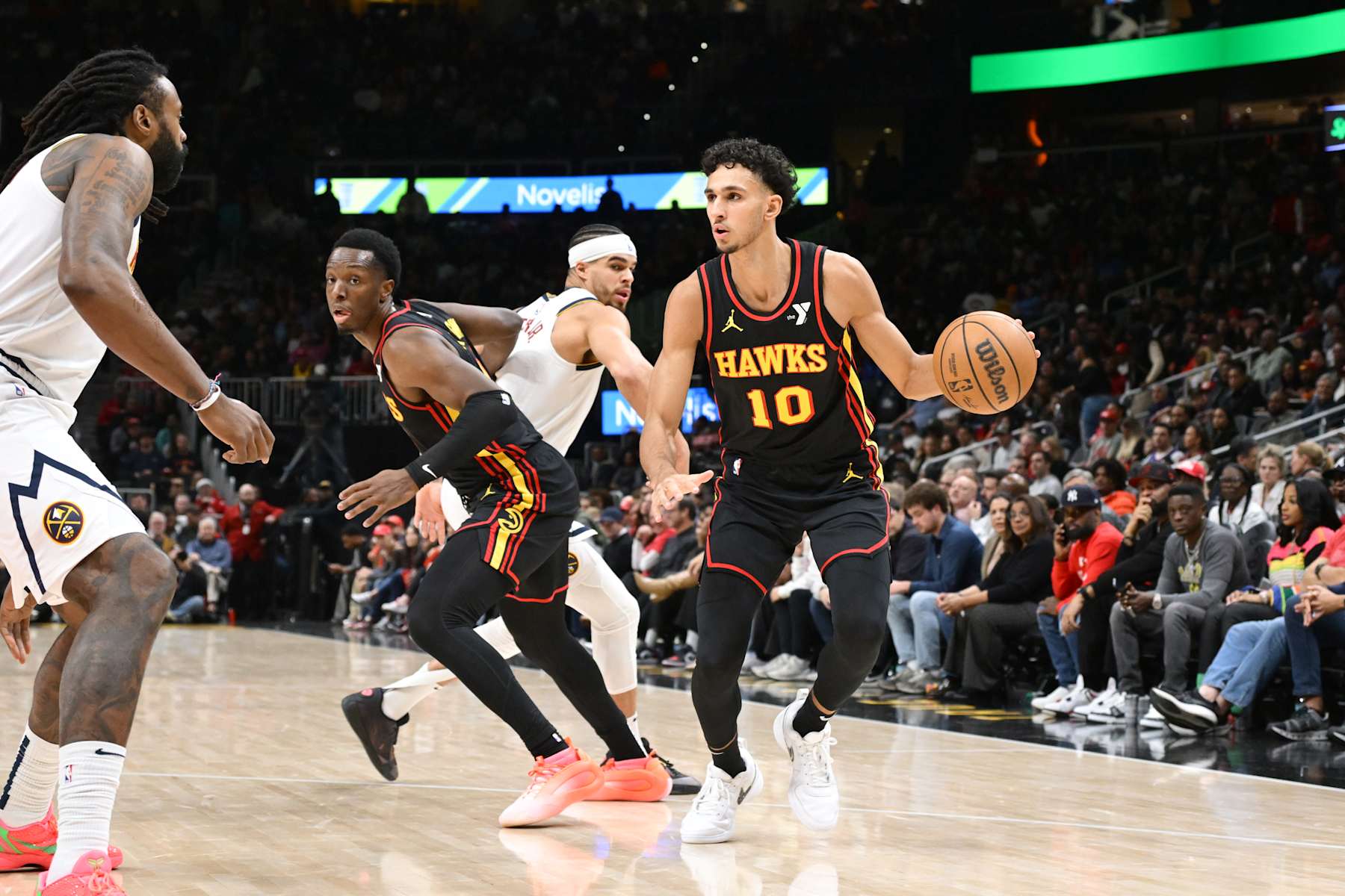 ATLANTA, GA - DECEMBER 8: Zaccharie Risacher #10 of the Atlanta Hawks dribbles the ball during the game against the Denver Nuggets on December 8, 2024 at State Farm Arena in Atlanta, Georgia.  NOTE TO USER: User expressly acknowledges and agrees that, by downloading and/or using this Photograph, user is consenting to the terms and conditions of the Getty Images License Agreement. Mandatory Copyright Notice: Copyright 2024 NBAE (Photo by Adam Hagy/NBAE via Getty Images)