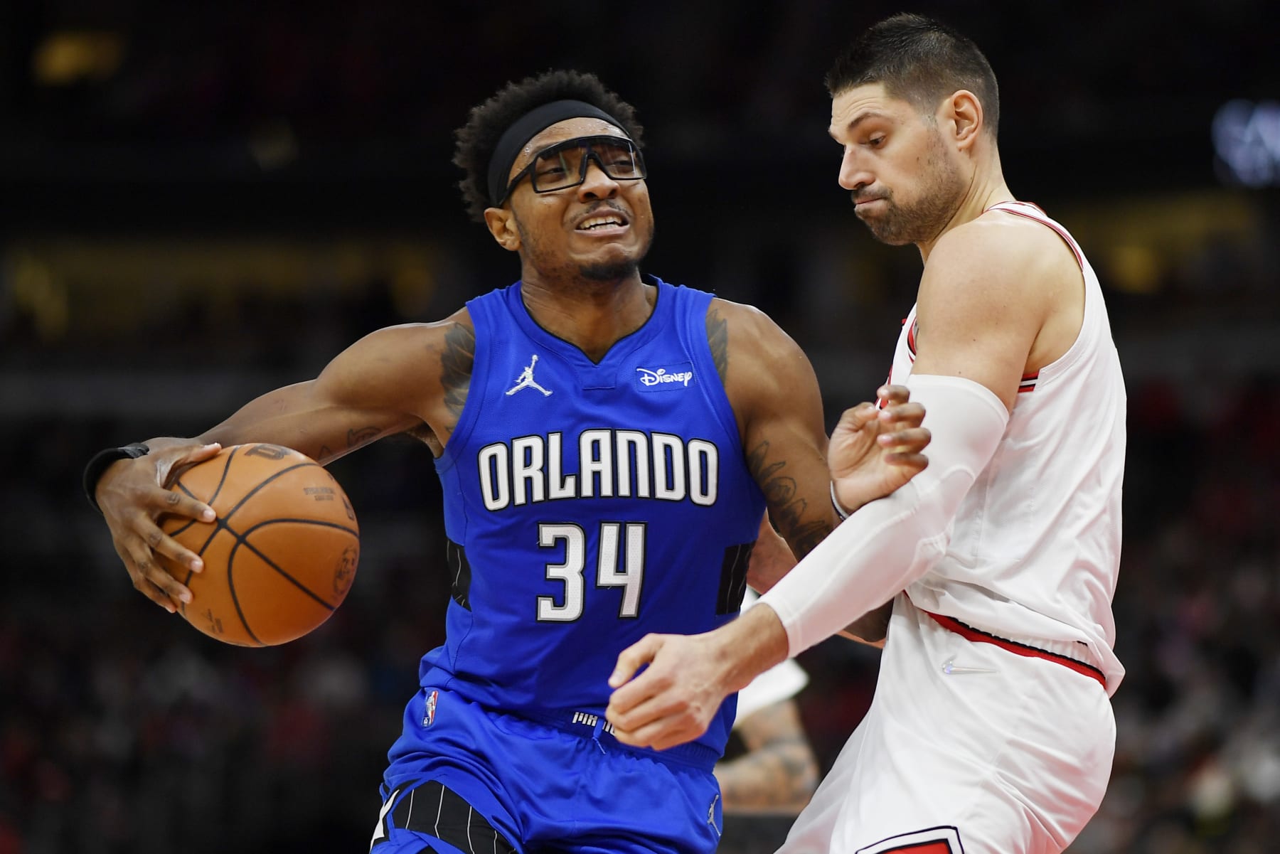 CHICAGO, ILLINOIS - JANUARY 03: Wendell Carter Jr. #34 of the Orlando Magic drives to the basket in the second half against Nikola Vucevic #9 of the Chicago Bulls at United Center on January 03, 2022 in Chicago, Illinois.  NOTE TO USER: User expressly acknowledges and agrees that, by downloading and or using this photograph, User is consenting to the terms and conditions of the Getty Images License Agreement. (Photo by Quinn Harris/Getty Images)