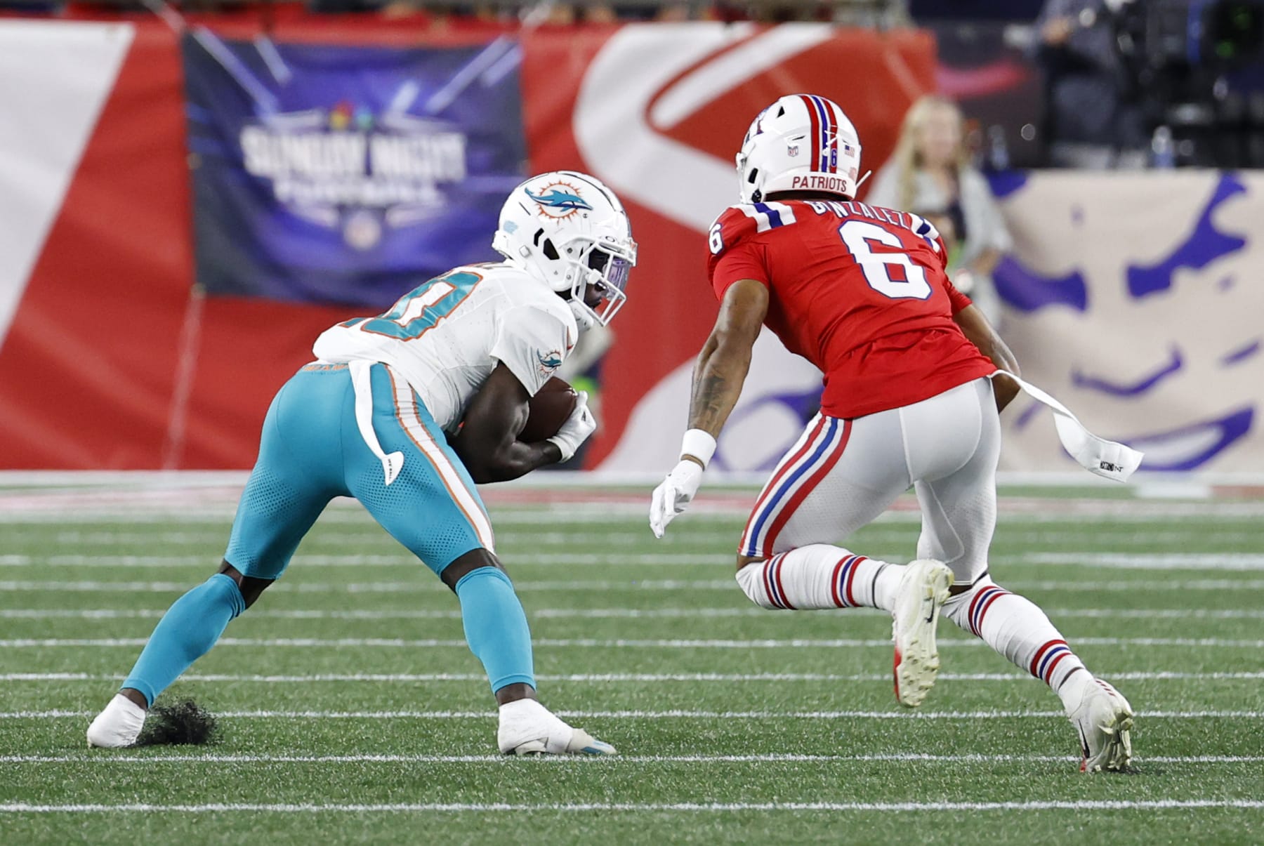 FOXBOROUGH, MA - SEPTEMBER 17: Miami Dolphins wide receiver Tyreek Hill (10) grabs the ball in front of New England Patriots cornerback Christian Gonzalez (6) during a game between the New England Patriots and the Miami Dolphins on September 17, 2023, at Gillette Stadium in Foxborough, Massachusetts. (Photo by Fred Kfoury III/Icon Sportswire via Getty Images)