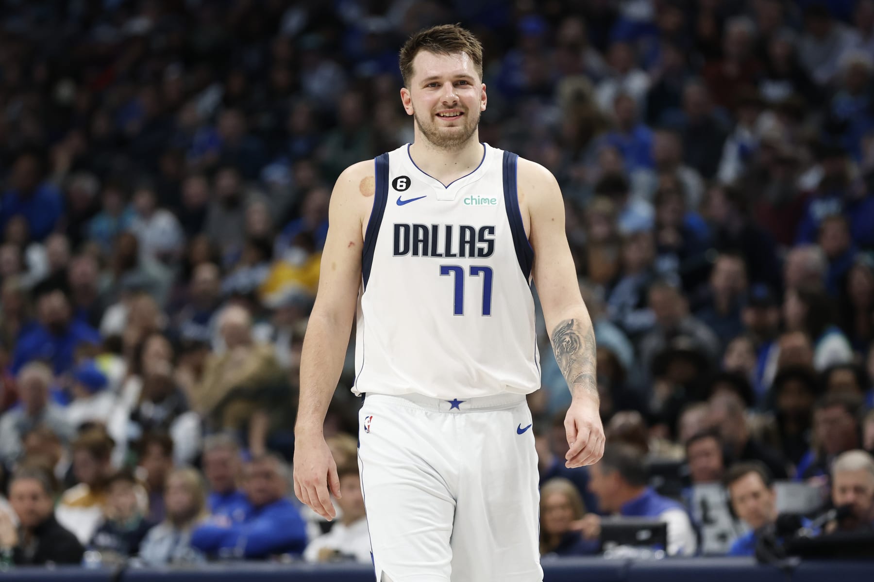 DALLAS, TEXAS - DECEMBER 29: Luka Doncic #77 of the Dallas Mavericks smiles while on the court in the game against the Houston Rockets  at American Airlines Center on December 29, 2022 in Dallas, Texas.  NOTE TO USER: User expressly acknowledges and agrees that, by downloading and or using this photograph, User is consenting to the terms and conditions of the Getty Images License Agreement. (Photo by Tim Heitman/Getty Images)