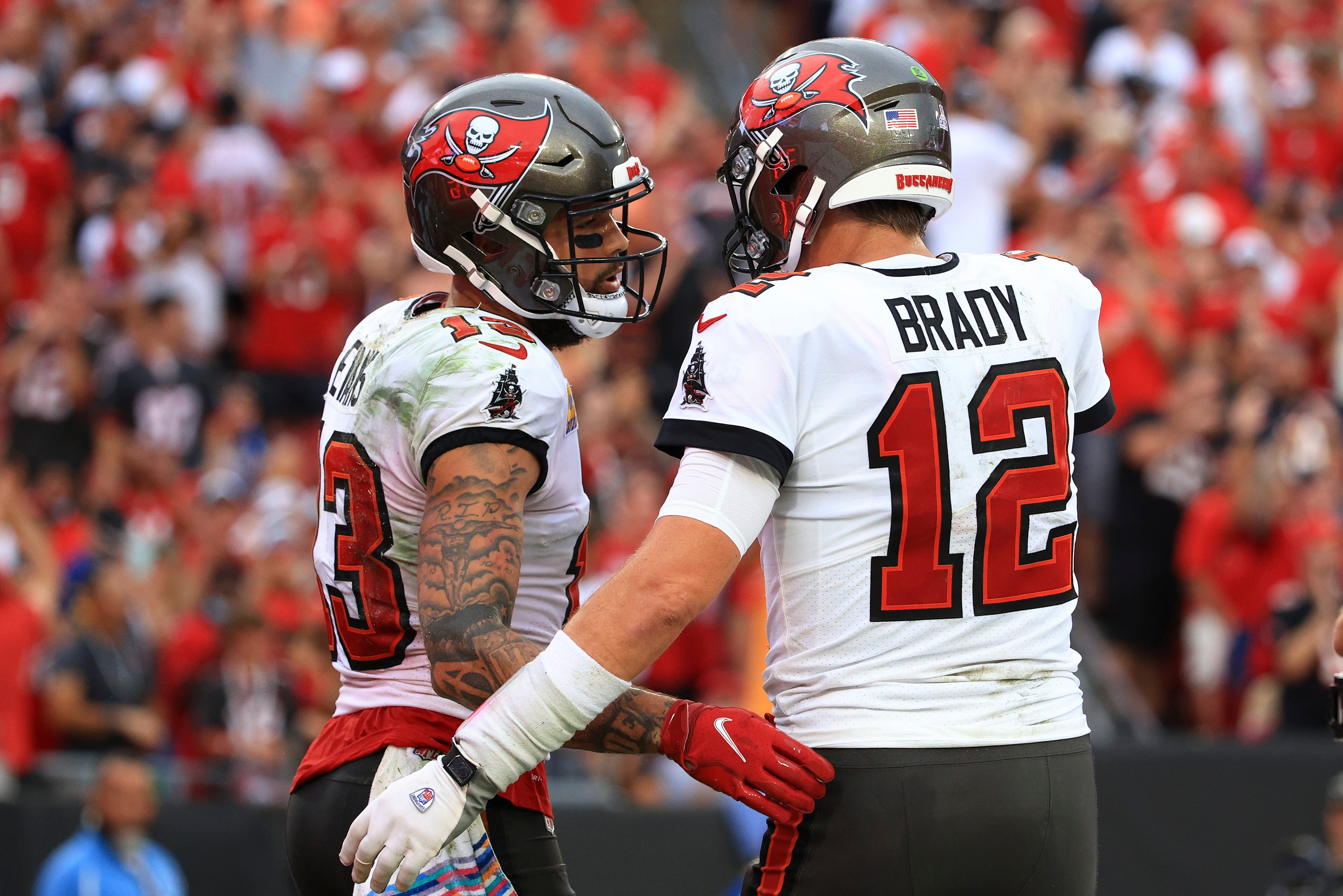 TAMPA, FLORIDA - OCTOBER 24: Mike Evans #13 and Tom Brady #12 of the Tampa Bay Buccaneers celebrate after scoring a touchdown in the second quarter against the Chicago Bears in the game at Raymond James Stadium on October 24, 2021 in Tampa, Florida. (Photo by Mike Ehrmann/Getty Images)