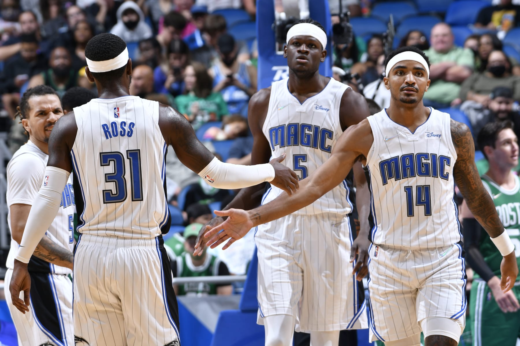 ORLANDO, FL - OCTOBER 13: Gary Harris #14 of the Orlando Magic high fives Terrence Ross #31 of the Orlando Magic during a preseason game against the Boston Celtics on October 13, 2021 at Amway Center in Orlando, Florida. NOTE TO USER: User expressly acknowledges and agrees that, by downloading and or using this photograph, User is consenting to the terms and conditions of the Getty Images License Agreement. Mandatory Copyright Notice: Copyright 2021 NBAE (Photo by Fernando Medina/NBAE via Getty Images)
