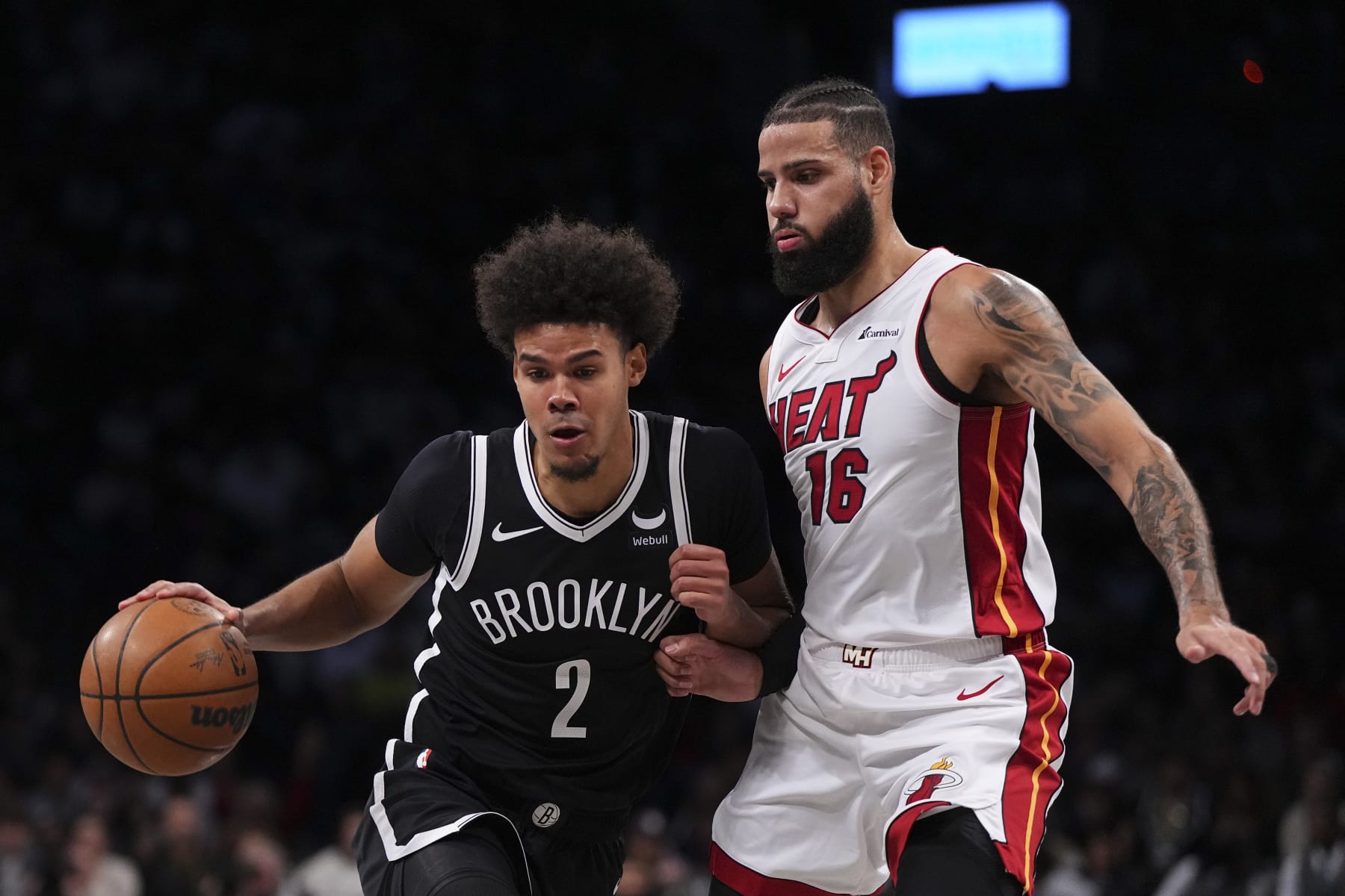 NEW YORK, NEW YORK - NOVEMBER 25: Cameron Johnson #2 of the Brooklyn Nets drives to the basket against Caleb Martin #16 of the Miami Heat in the first half at Barclays Center on November 25, 2023 in the Brooklyn borough of New York City. NOTE TO USER: User expressly acknowledges and agrees that, by downloading and or using this photograph, User is consenting to the terms and conditions of the Getty Images License Agreement. (Photo by Mitchell Leff/Getty Images)