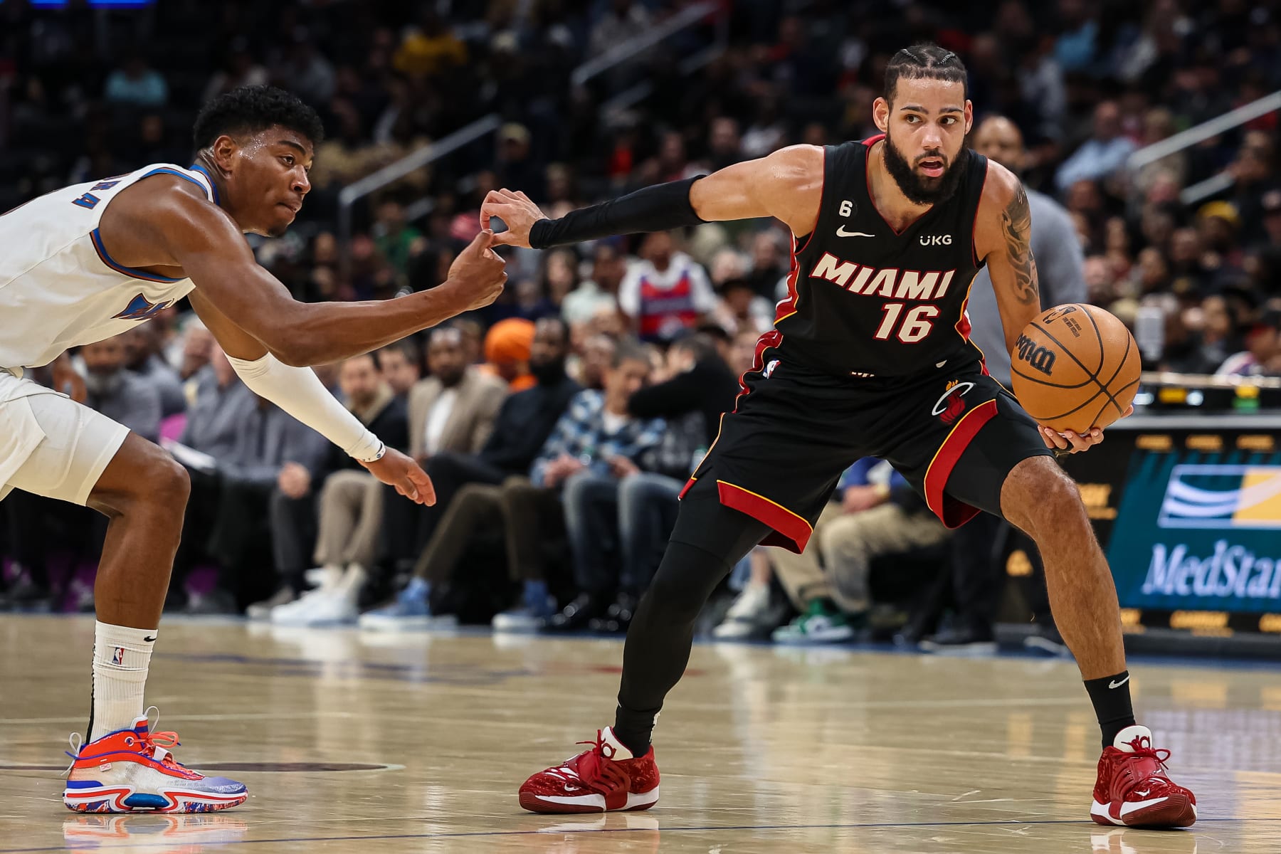 WASHINGTON, DC - NOVEMBER 18: Caleb Martin #16 of the Miami Heat handles the ball as Rui Hachimura #8 of the Washington Wizards defends during the first half at Capital One Arena on November 18, 2022 in Washington, DC. NOTE TO USER: User expressly acknowledges and agrees that, by downloading and or using this photograph, User is consenting to the terms and conditions of the Getty Images License Agreement. (Photo by Scott Taetsch/Getty Images)