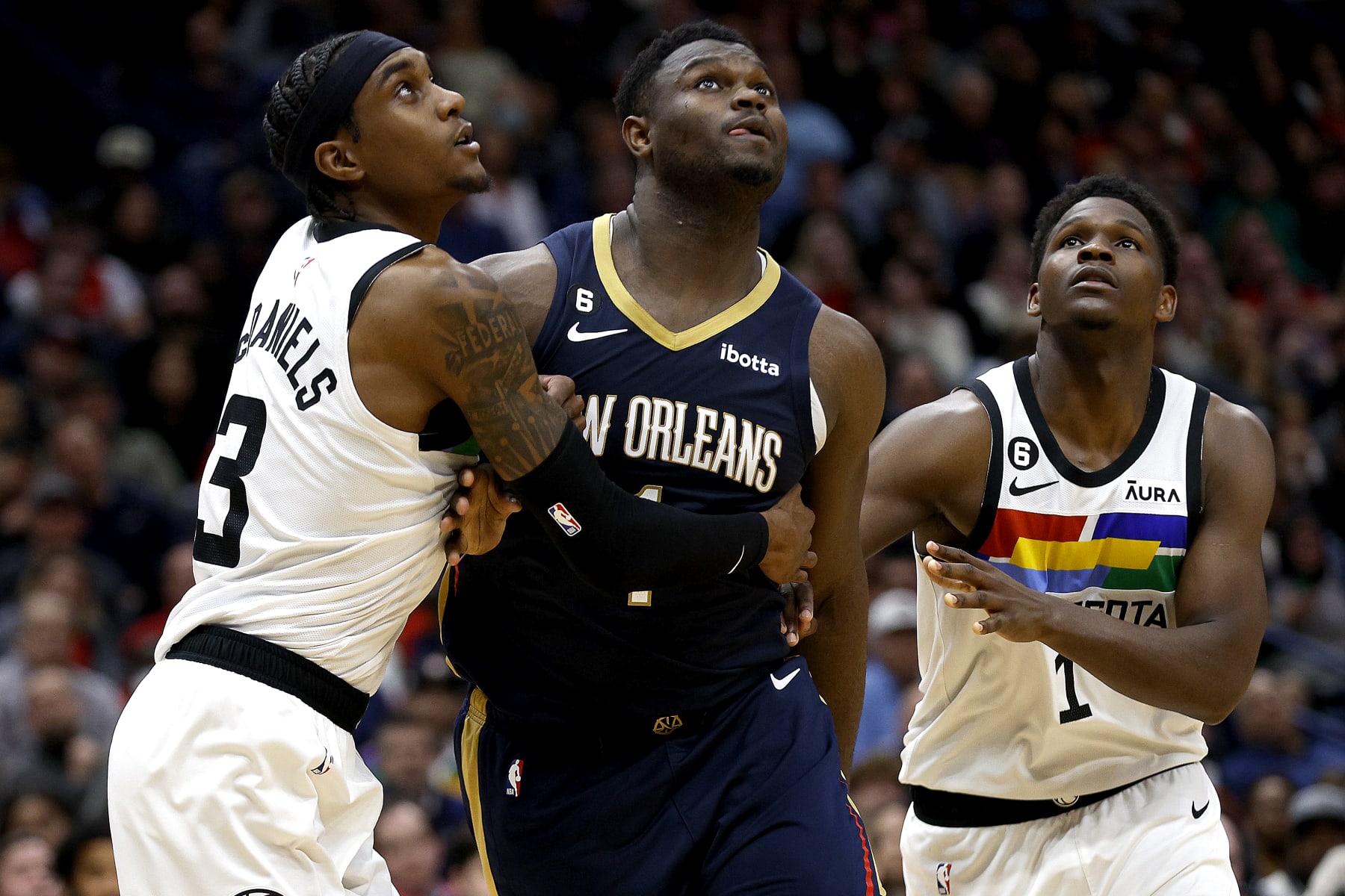 NEW ORLEANS, LOUISIANA - DECEMBER 28: Jaden McDaniels #3 of the Minnesota Timberwolves, Anthony Edwards #1 of the Minnesota Timberwolves and Zion Williamson #1 of the New Orleans Pelicans challenge for a rebound during the fourth quarter of an NBA game at Smoothie King Center on December 28, 2022 in New Orleans, Louisiana. NOTE TO USER: User expressly acknowledges and agrees that, by downloading and or using this photograph, User is consenting to the terms and conditions of the Getty Images License Agreement. (Photo by Sean Gardner/Getty Images)