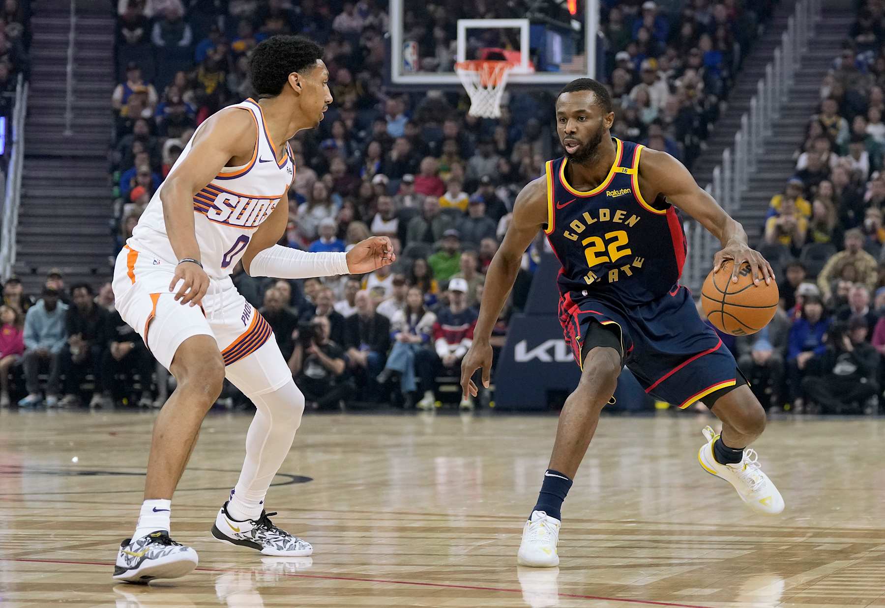 SAN FRANCISCO, CALIFORNIA - JANUARY 31: Andrew Wiggins #22 of the Golden State Warriors dribbling the ball is guarded by Ryan Dunn #0 of the Phoenix Suns during the first half of an NBA basketball game at Chase Center on January 31, 2025 in San Francisco, California. NOTE TO USER: User expressly acknowledges and agrees that, by downloading and or using this photograph, User is consenting to the terms and conditions of the Getty Images License Agreement. (Photo by Thearon W. Henderson/Getty Images)