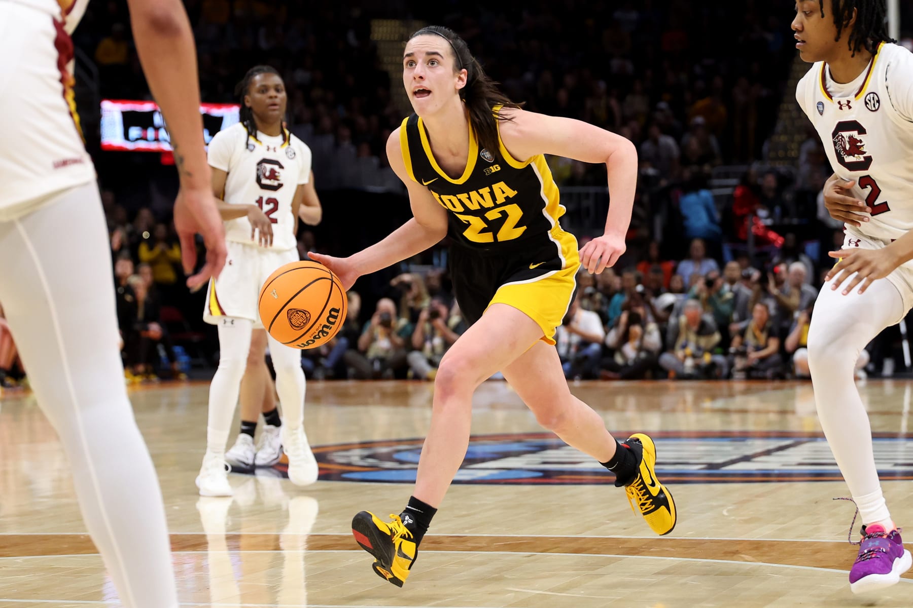 CLEVELAND, OHIO - APRIL 07: Caitlin Clark #22 of the Iowa Hawkeyes dribbles as Ashlyn Watkins #2 of the South Carolina Gamecocks looks on in the first half during the 2024 NCAA Women's Basketball Tournament National Championship at Rocket Mortgage FieldHouse on April 07, 2024 in Cleveland, Ohio. (Photo by Gregory Shamus/Getty Images)