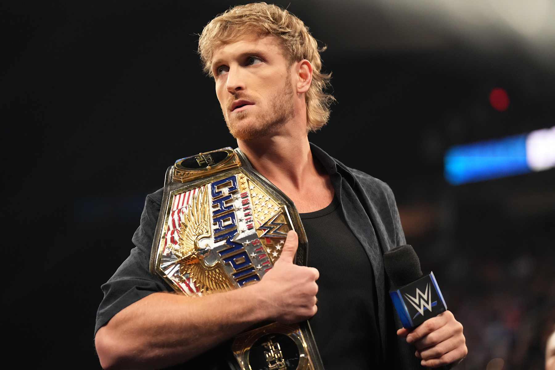 CLEVELAND, OHIO - AUGUST 2: United States Champion Logan Paul addresses the crowd during SmackDown at Rocket Mortgage FieldHouse on August 2, 2024 in Cleveland, Ohio.  (Photo by WWE/Getty Images)