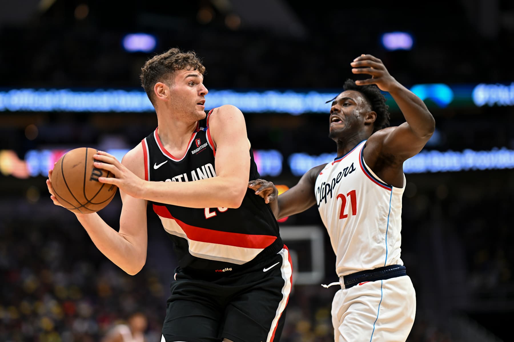 SEATTLE, WASHINGTON - OCTOBER 11: Donovan Clingan #23 of the Portland Trail Blazers controls the ball against Kobe Brown #21 of the Los Angeles Clippers during the Rain City Showcase game at Climate Pledge Arena on October 11, 2024 in Seattle, Washington. The Los Angeles Clippers won 101-99. NOTE TO USER: User expressly acknowledges and agrees that, by downloading and or using this photograph, User is consenting to the terms and conditions of the Getty Images License Agreement. (Photo by Alika Jenner/Getty Images)