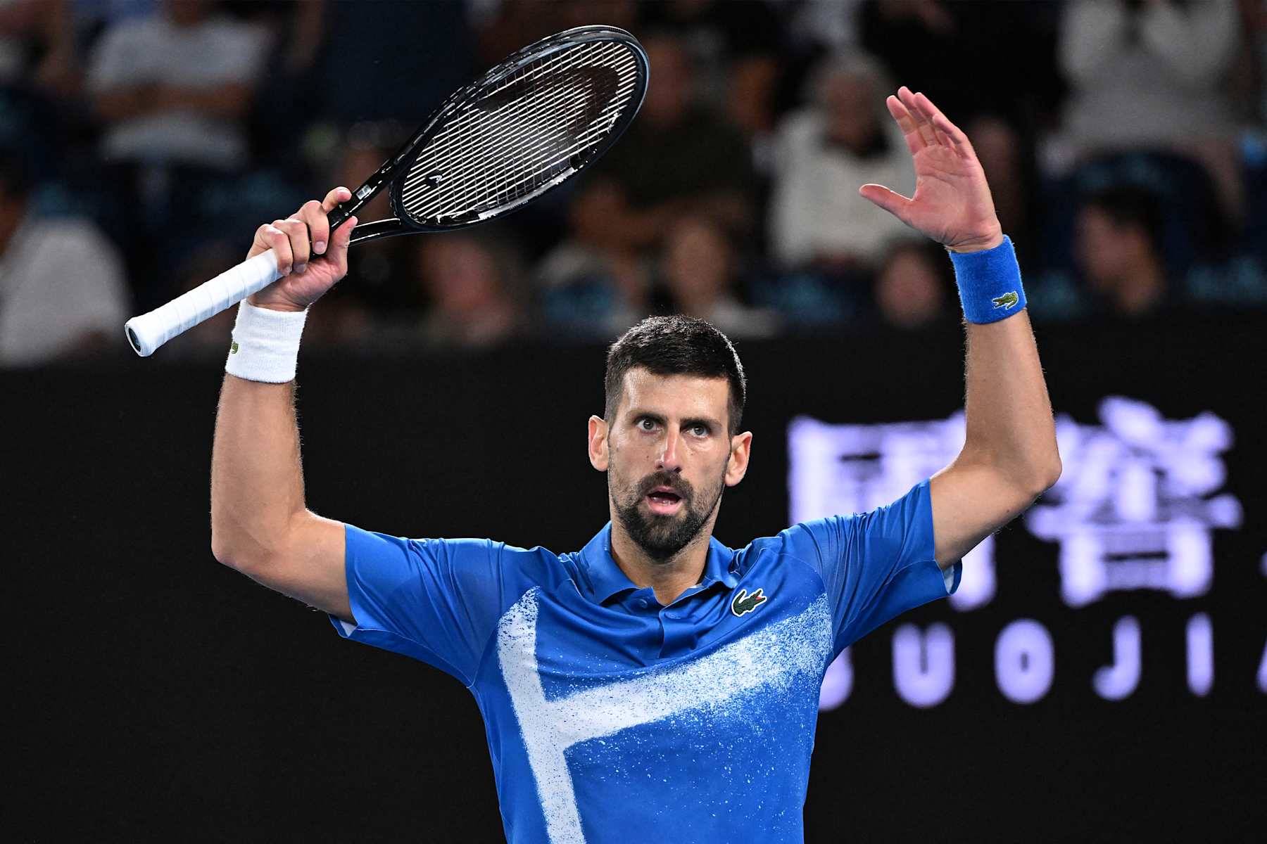 Serbia's Novak Djokovic reacts to a point against Spain's Carlos Alcaraz during their men's singles quarterfinal match on day ten of the Australian Open tennis tournament in Melbourne on January 22, 2025. (Photo by WILLIAM WEST / AFP) / -- IMAGE RESTRICTED TO EDITORIAL USE - STRICTLY NO COMMERCIAL USE -- (Photo by WILLIAM WEST/AFP via Getty Images)