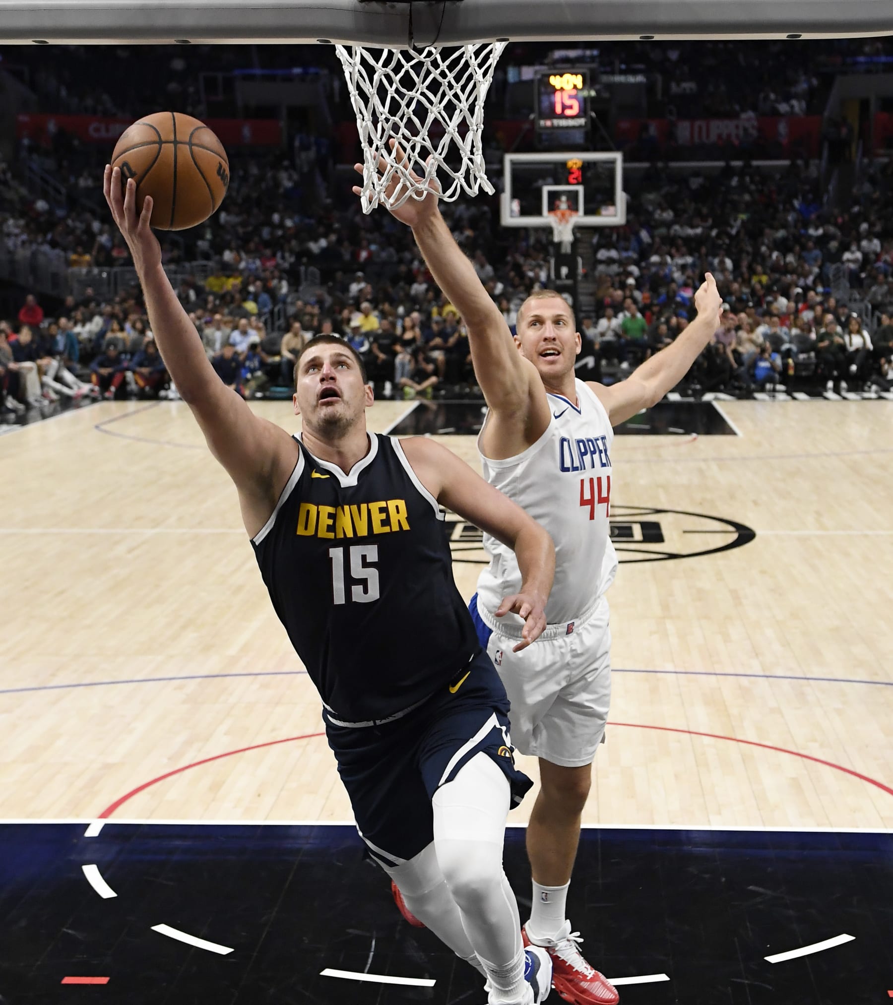 LOS ANGELES, CALIFORNIA - OCTOBER 19: Nikola Jokic #15 of the Denver Nuggets drives to the basket against Mason Plumlee #44 of the Los Angeles Clippers during the second half of a preseason game at Crypto.com Arena on October 19, 2023 in Los Angeles, California. NOTE TO USER: User expressly acknowledges and agrees that, by downloading and or using this photograph, User is consenting to the terms and conditions of the Getty Images License Agreement. (Photo by Kevork Djansezian/Getty Images)