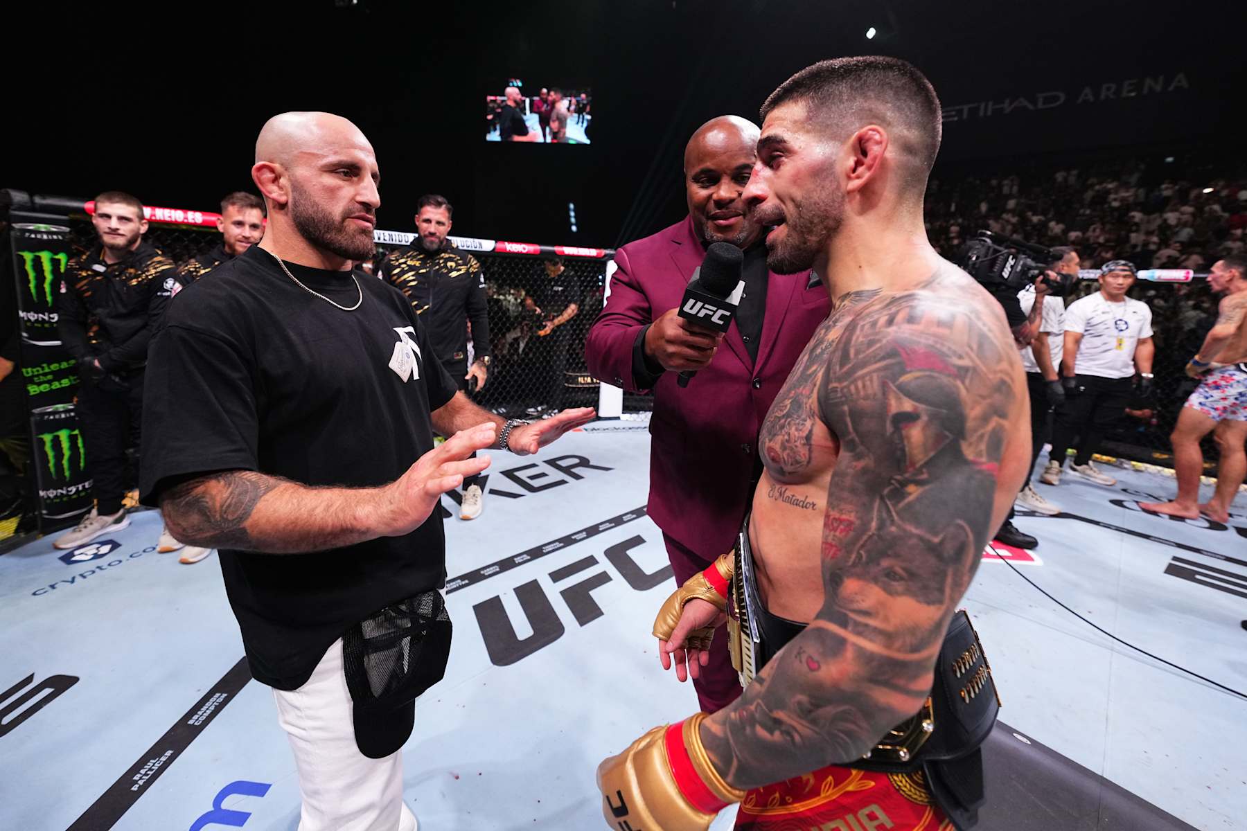 ABU DHABI, UNITED ARAB EMIRATES - OCTOBER 26: (R-L) Ilia Topuria of Spain has words with former champion Alexander Volkanovski after his victory against Max Holloway in the UFC featherweight championship fight during the UFC 308 event at Etihad Arena on October 26, 2024 in Abu Dhabi, United Arab Emirates.  (Photo by Chris Unger/Zuffa LLC)
