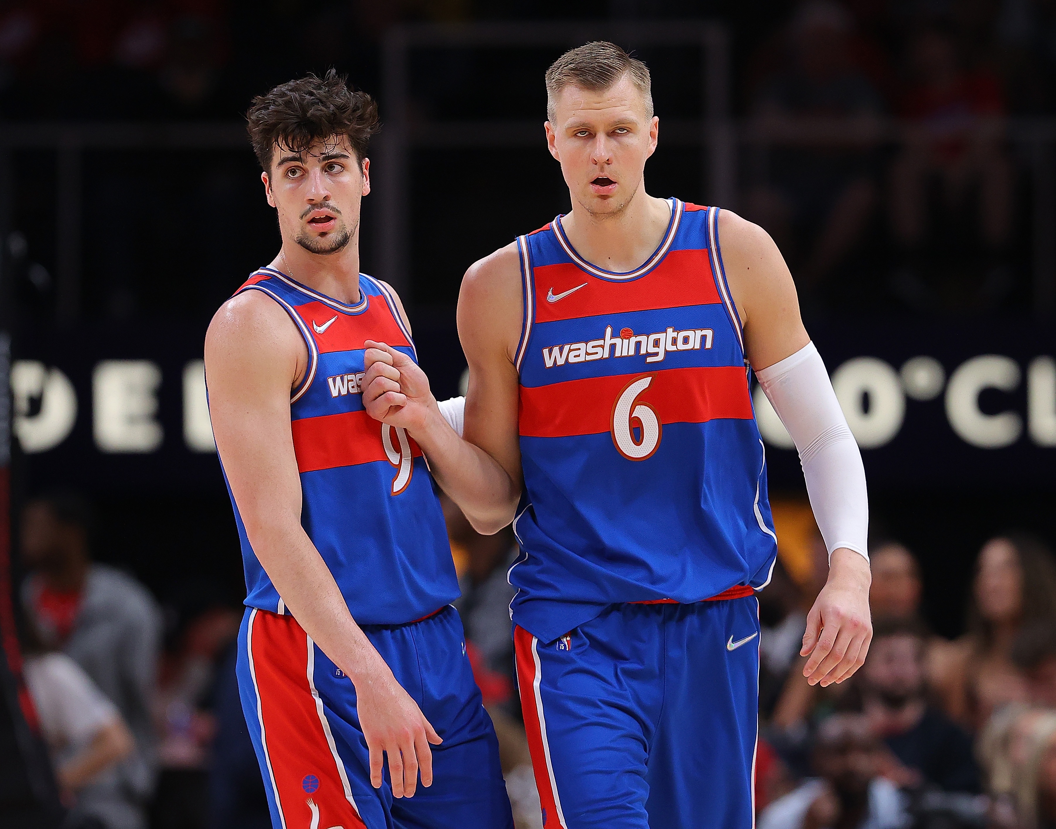 ATLANTA, GEORGIA - APRIL 06:  Kristaps Porzingis #6 of the Washington Wizards reacts after hitting a three-point basket against the Atlanta Hawks with Deni Avdija #9 during the first half at State Farm Arena on April 06, 2022 in Atlanta, Georgia.  NOTE TO USER: User expressly acknowledges and agrees that, by downloading and or using this photograph, User is consenting to the terms and conditions of the Getty Images License Agreement. (Photo by Kevin C. Cox/Getty Images)