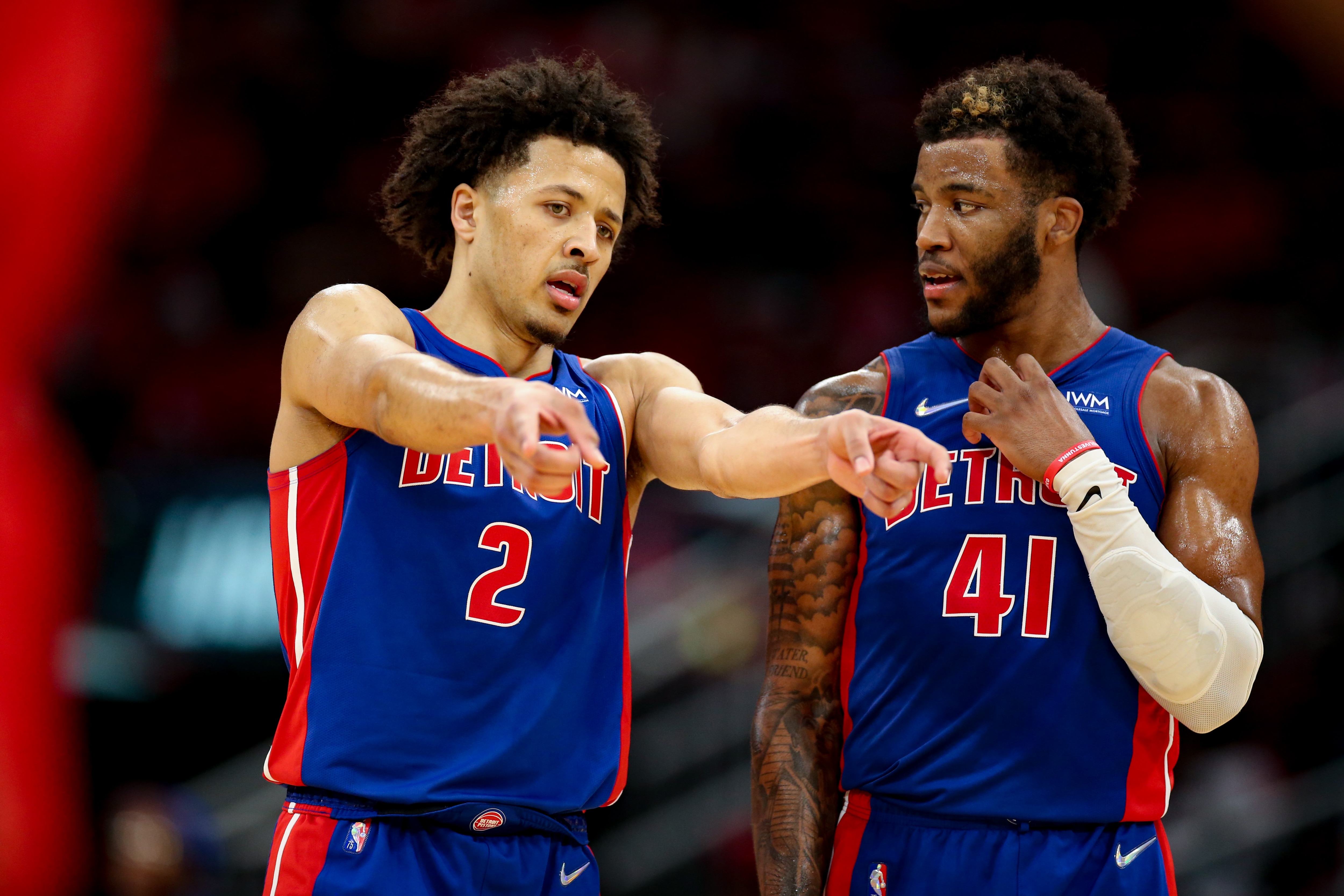 HOUSTON, TEXAS - NOVEMBER 10: Cade Cunningham #2 of the Detroit Pistons speaks with Saddiq Bey #41 during the second half against the Houston Rockets at Toyota Center on November 10, 2021 in Houston, Texas. NOTE TO USER: User expressly acknowledges and agrees that, by downloading and or using this photograph, User is consenting to the terms and conditions of the Getty Images License Agreement. (Photo by Carmen Mandato/Getty Images)
