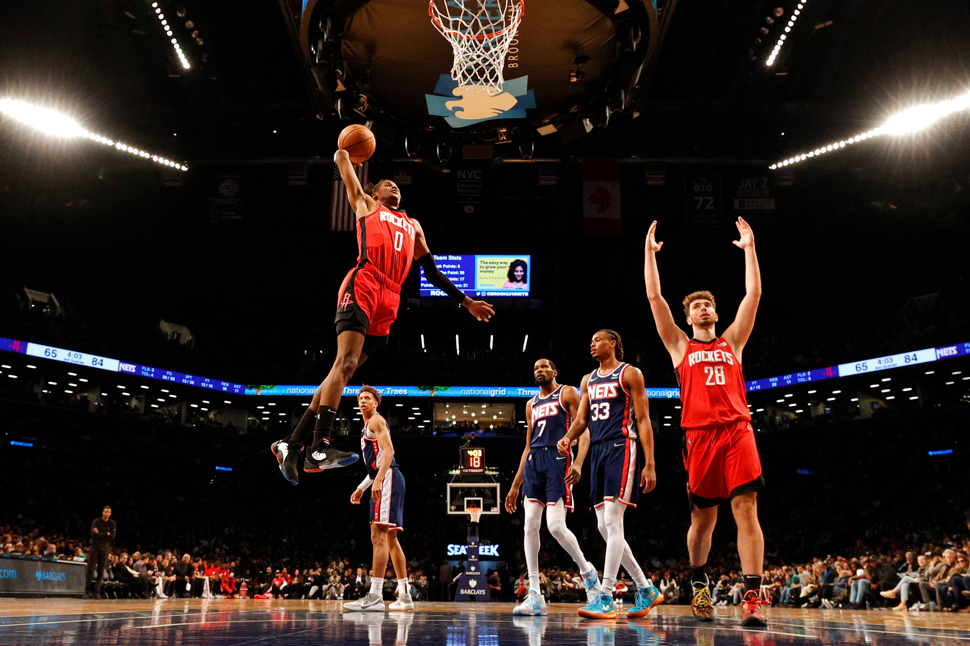 NEW YORK, NEW YORK - APRIL 05: Jalen Green #0 goes to the basket as teammate Alperen Sengun #28 of the Houston Rockets reacts and Kessler Edwards #14, Kevin Durant #7, and Nic Claxton #33 of the Brooklyn Nets look on during the game at Barclays Center on April 05, 2022 in the Brooklyn borough of New York City. The Nets won 118-105. NOTE TO USER: User expressly acknowledges and agrees that, by downloading and or using this photograph, User is consenting to the terms and conditions of the Getty Images License Agreement. (Photo by Sarah Stier/Getty Images)