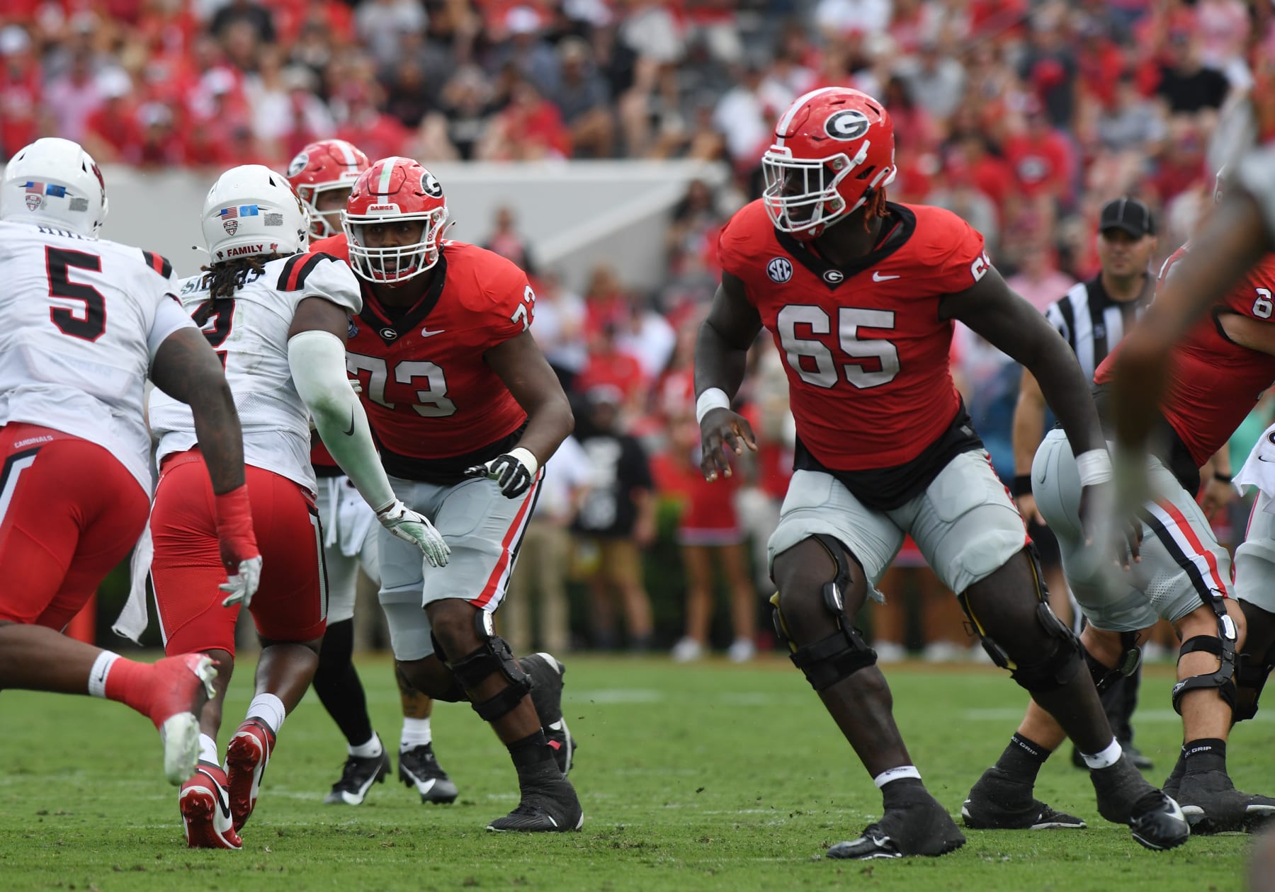 ATHENS, GA - SEPTEMBER 09: Georgia Bulldogs Offensive Linemen Xavier Truss (73) and Georgia Bulldogs Offensive Linemen Amarius Mims (65) block during the college football game between the Ball State Cardinals and the Georgia Bulldogs on September 09, 2023, at Sanford Stadium in Athens, GA. (Photo by Jeffrey Vest/Icon Sportswire via Getty Images)