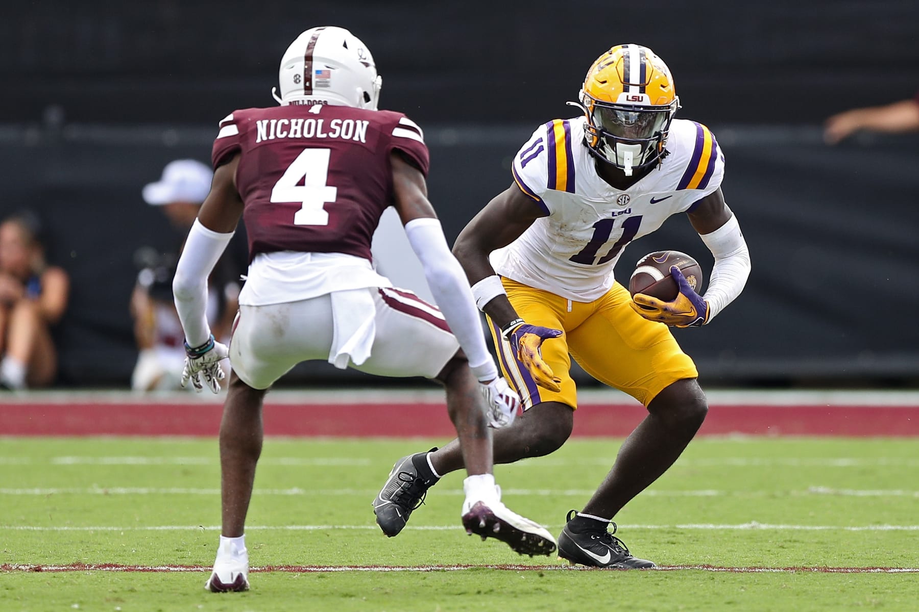 STARKVILLE, MISSISSIPPI - SEPTEMBER 16: Brian Thomas Jr. #11 of the LSU Tigers carries the ball during the second half against DeCarlos Nicholson #4 of the Mississippi State Bulldogs at Davis Wade Stadium on September 16, 2023 in Starkville, Mississippi. (Photo by Justin Ford/Getty Images)