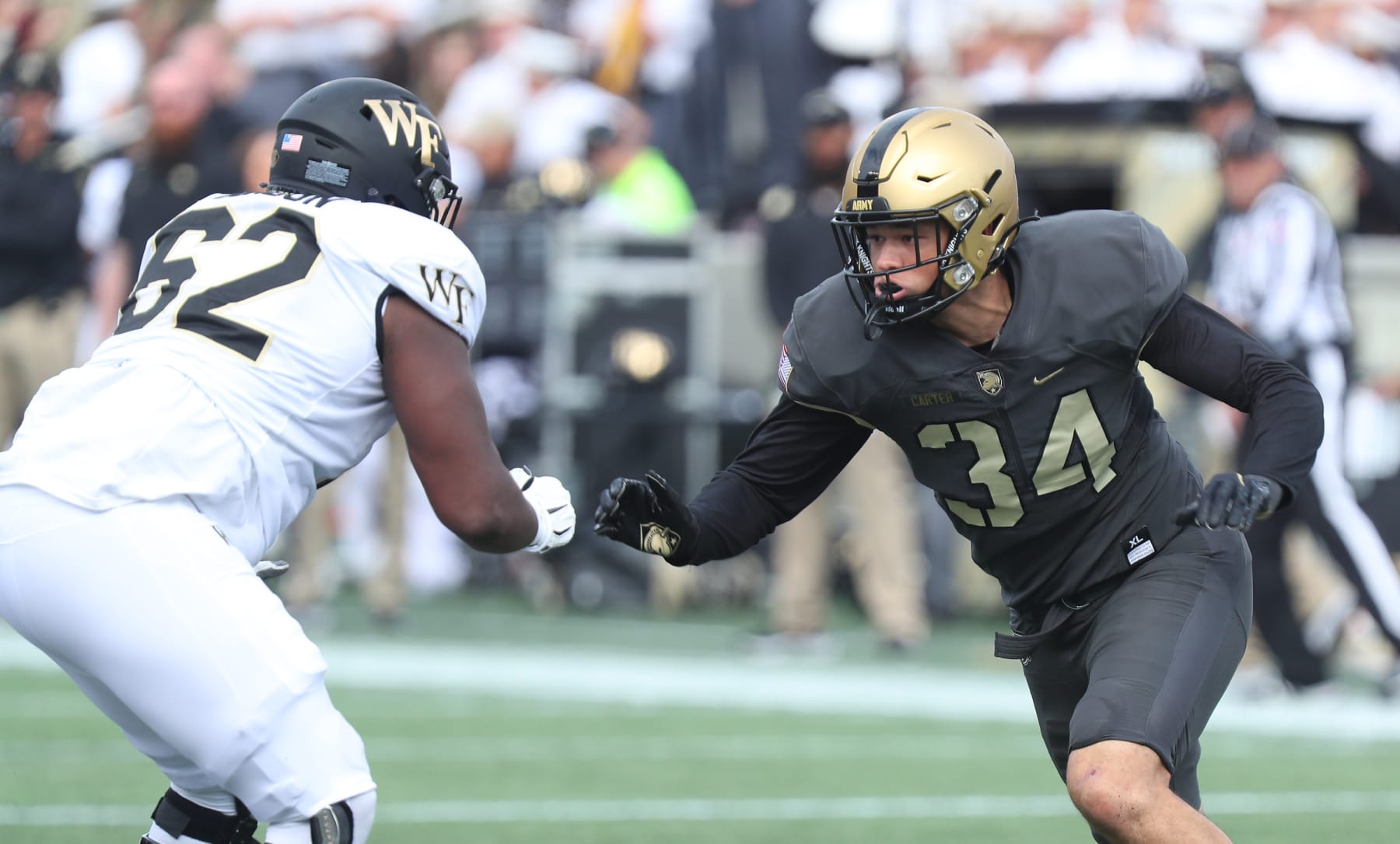 WEST POINT, NY - OCTOBER 23: Andre Carter II #34 of the Army Black Knights applies pressure against DeVonte Gordon #62 of the Wake Forest Demon Deacons during the game at Michie Stadium on October 23, 2021 in West Point, New York. (Photo by Edward Diller/Getty Images)