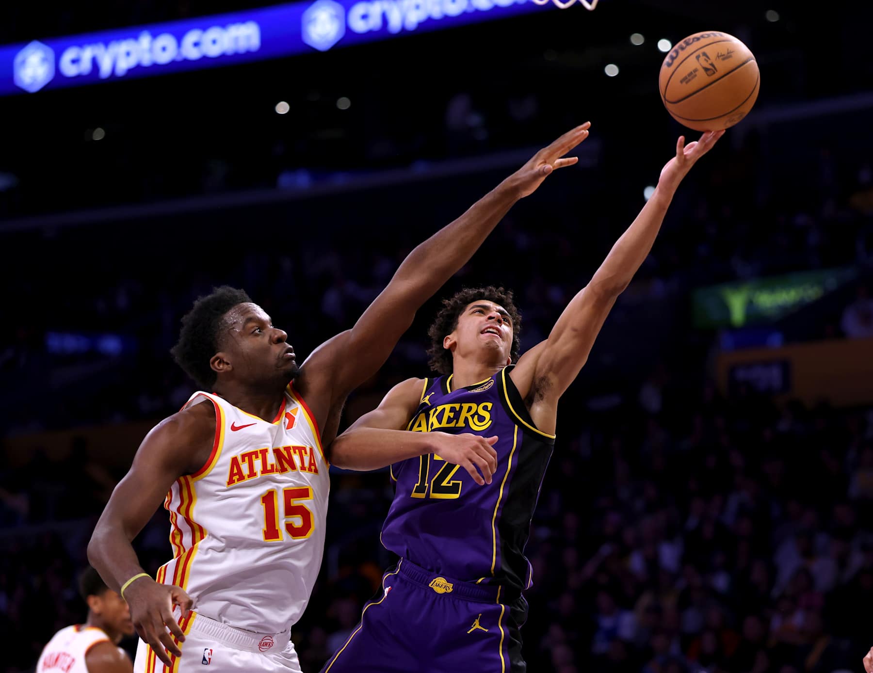 LOS ANGELES, CALIFORNIA - JANUARY 03: Max Christie #12 of the Los Angeles Lakers scores as he is fouled by Clint Capela #15 of the Atlanta Hawks during a 119-102 Lakers win at Crypto.com Arena on January 03, 2025 in Los Angeles, California. NOTE TO USER: User expressly acknowledges and agrees that, by downloading and or using this photograph, User is consenting to the terms and conditions of the Getty Images License Agreement. (Photo by Harry How/Getty Images)